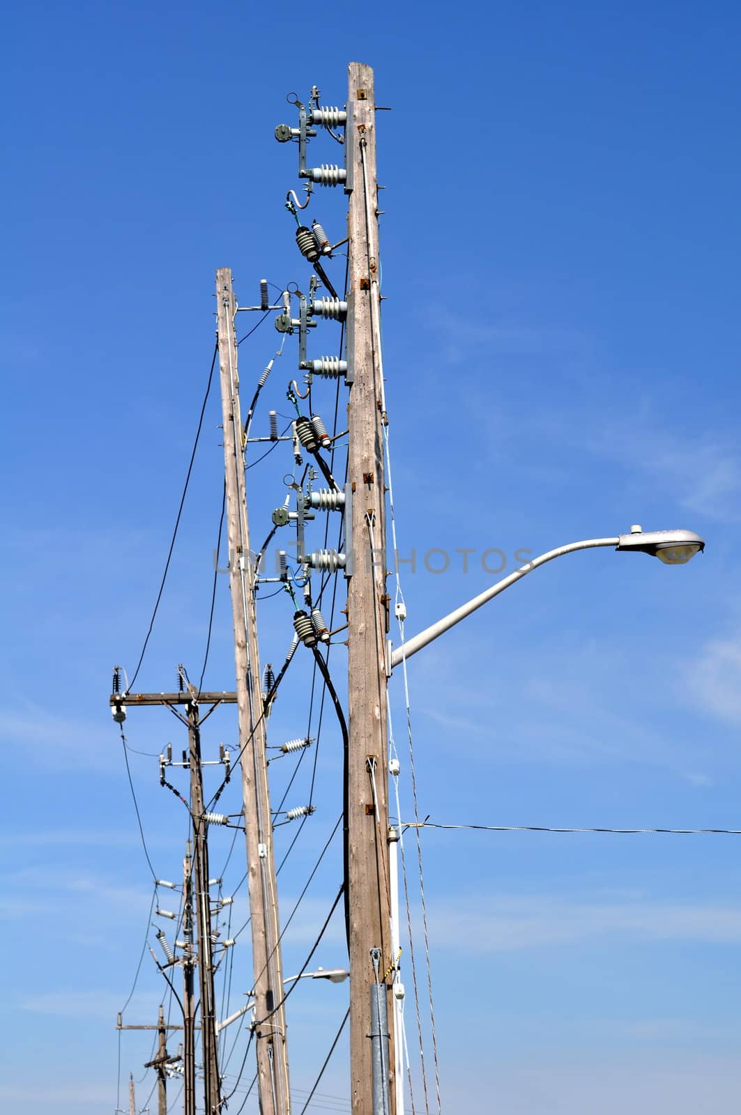 Electrical power pole with associated distribution lines and components.