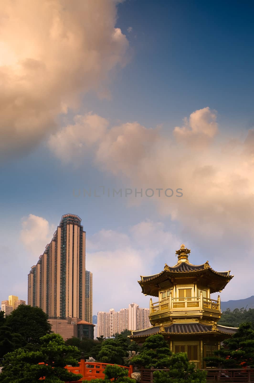 Golden Buddhism tower with modern tall buildings in the city.