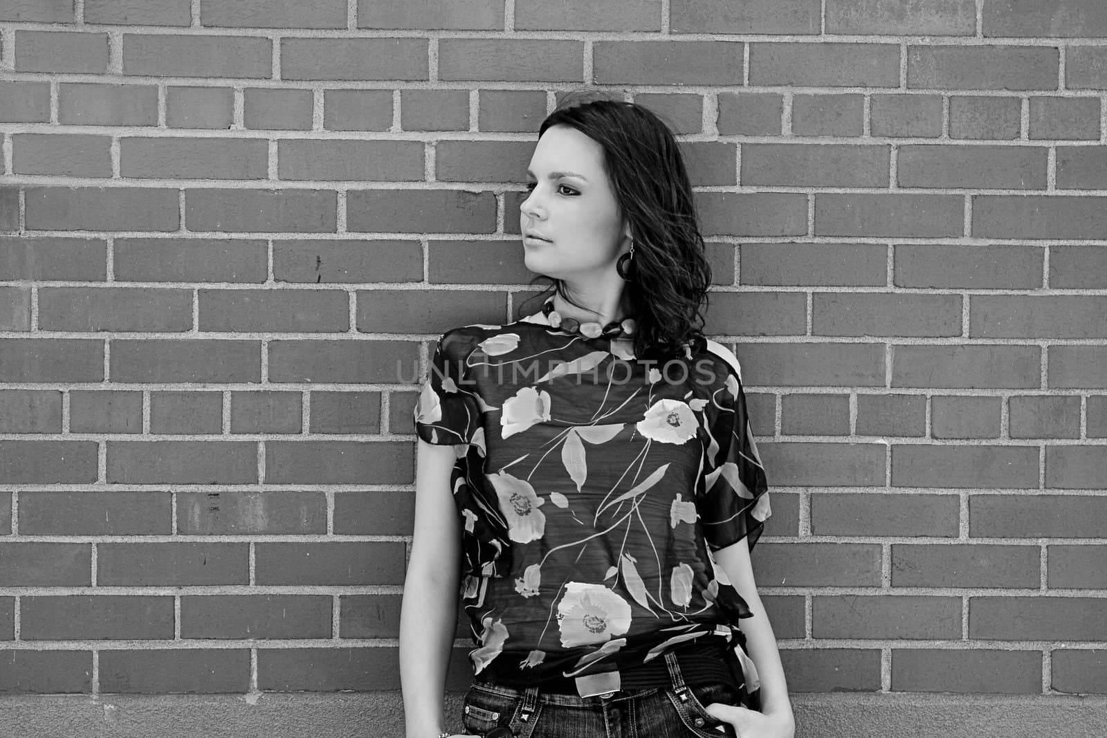 Young women with style against brick wall