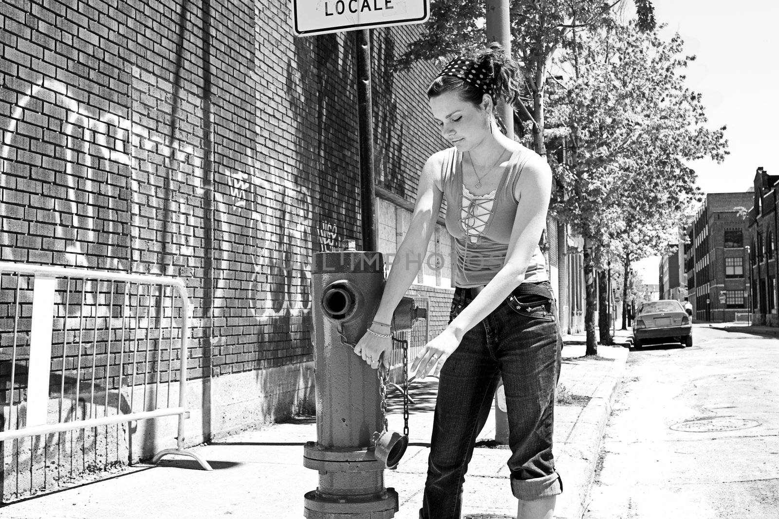 Teen girl playing with a fire hydrant