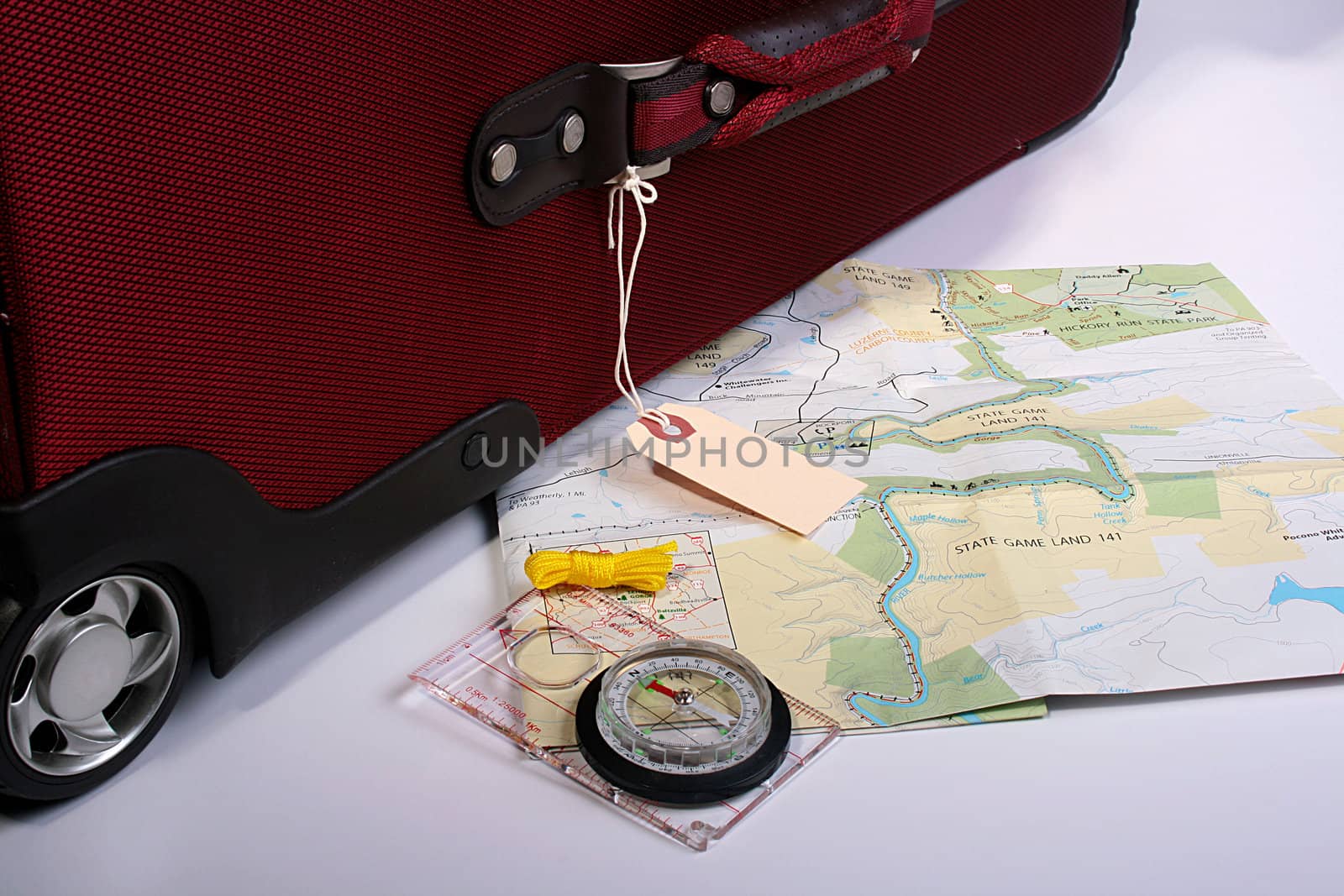 Red big suitcase with label and map for travel.