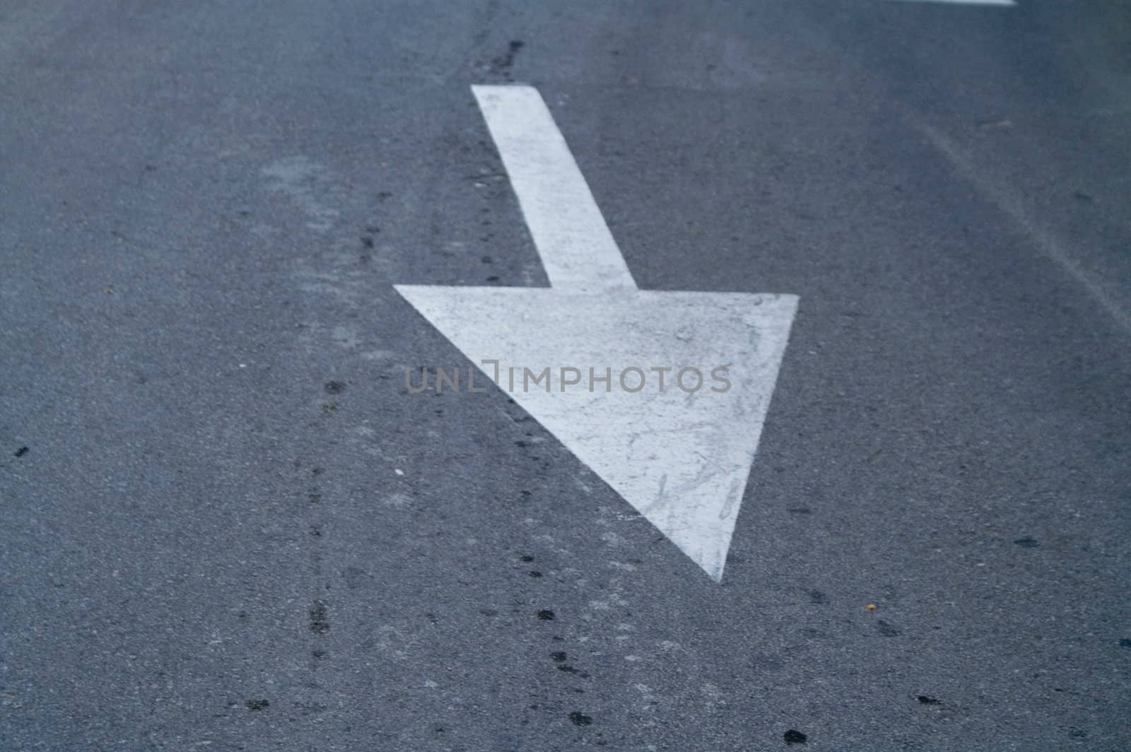 White direction arrow on the road 