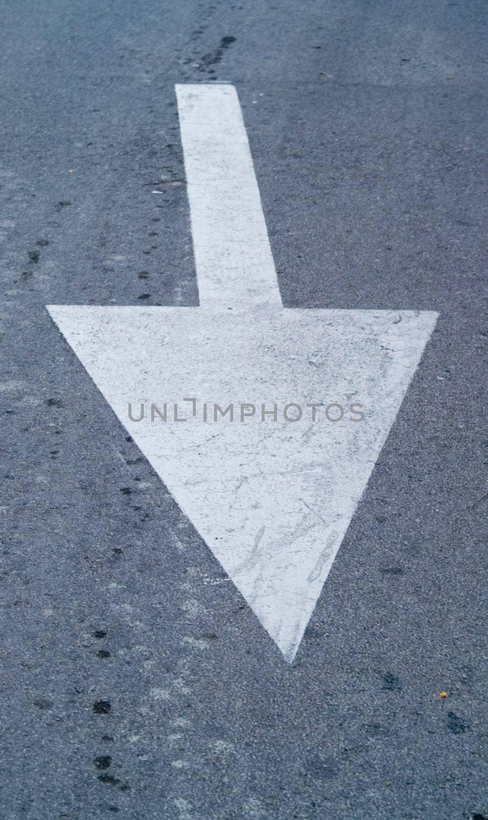 White direction arrow on the road 