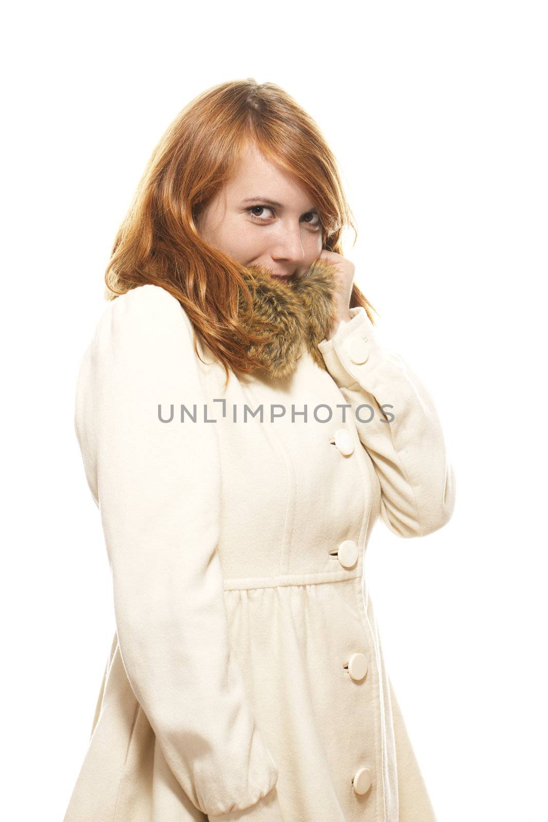 young redhead woman covering her face in fawn winter coat by RobStark