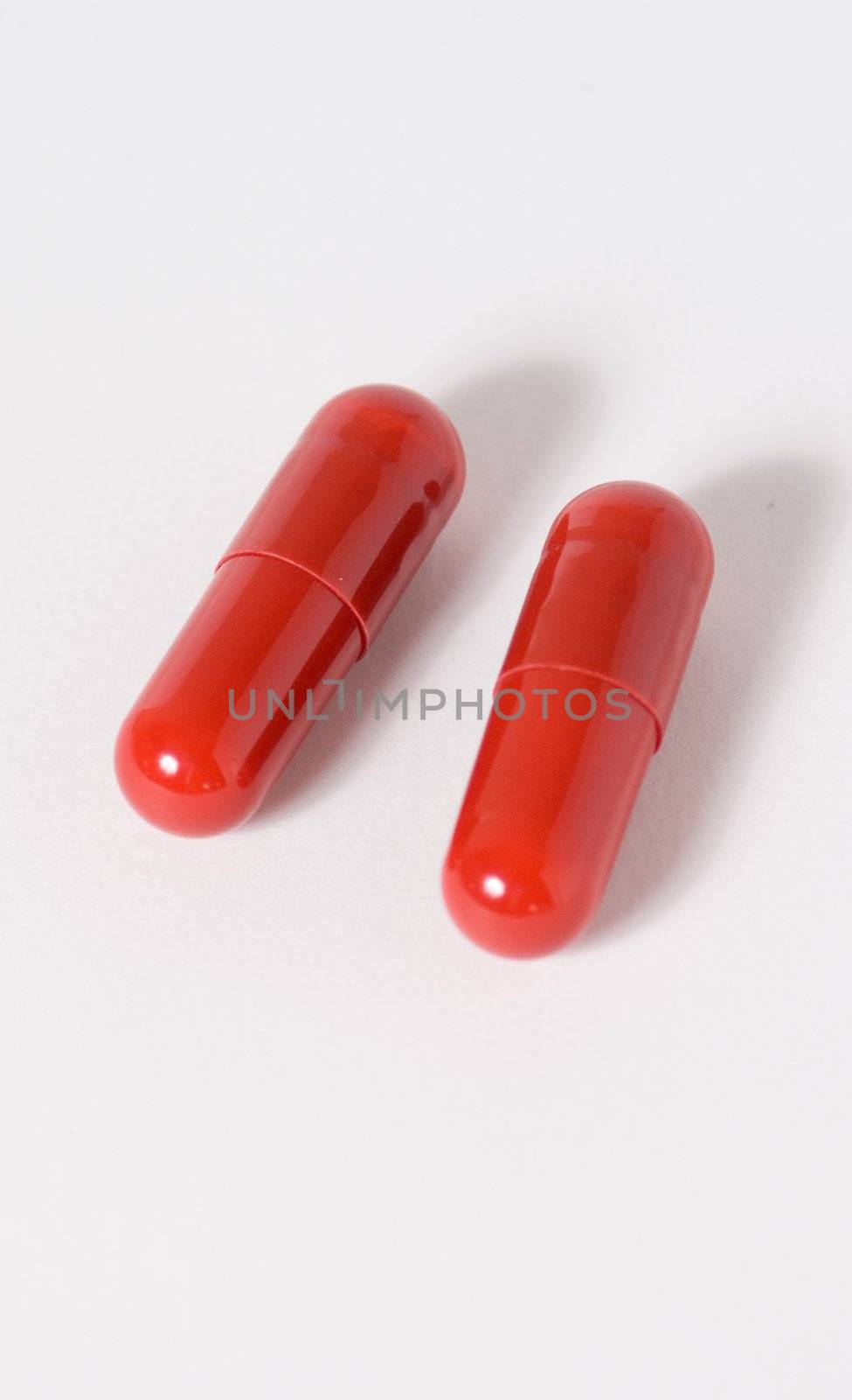 a couple of capsules on a white background