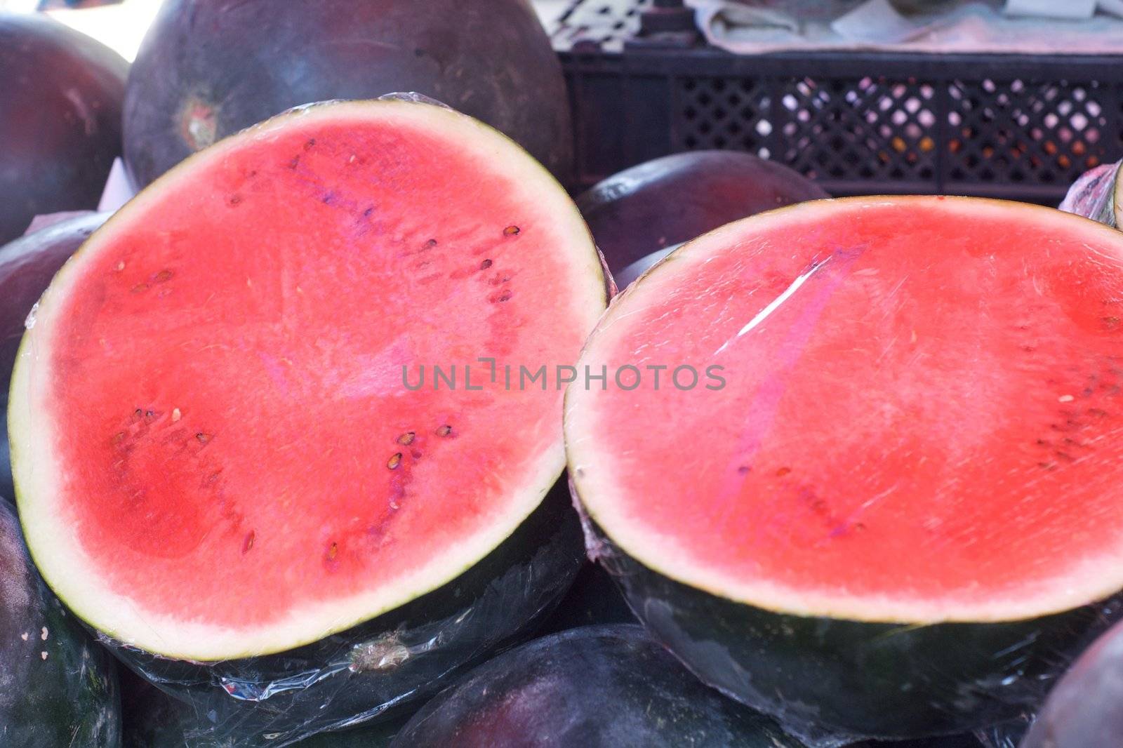 watermelon  summer fruit in a street market by olgaolga