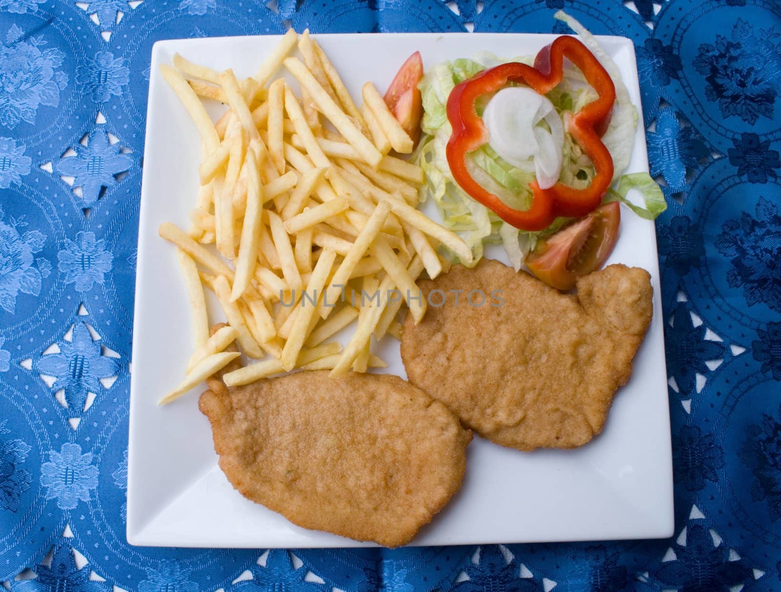 plate of steak with chips and vegetables