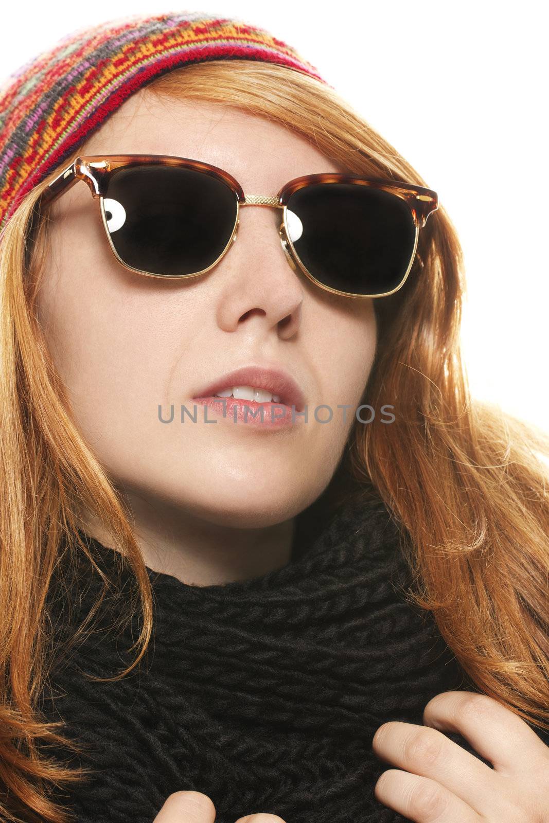 cool redhead woman wearing sunglasses in winter dress on white background