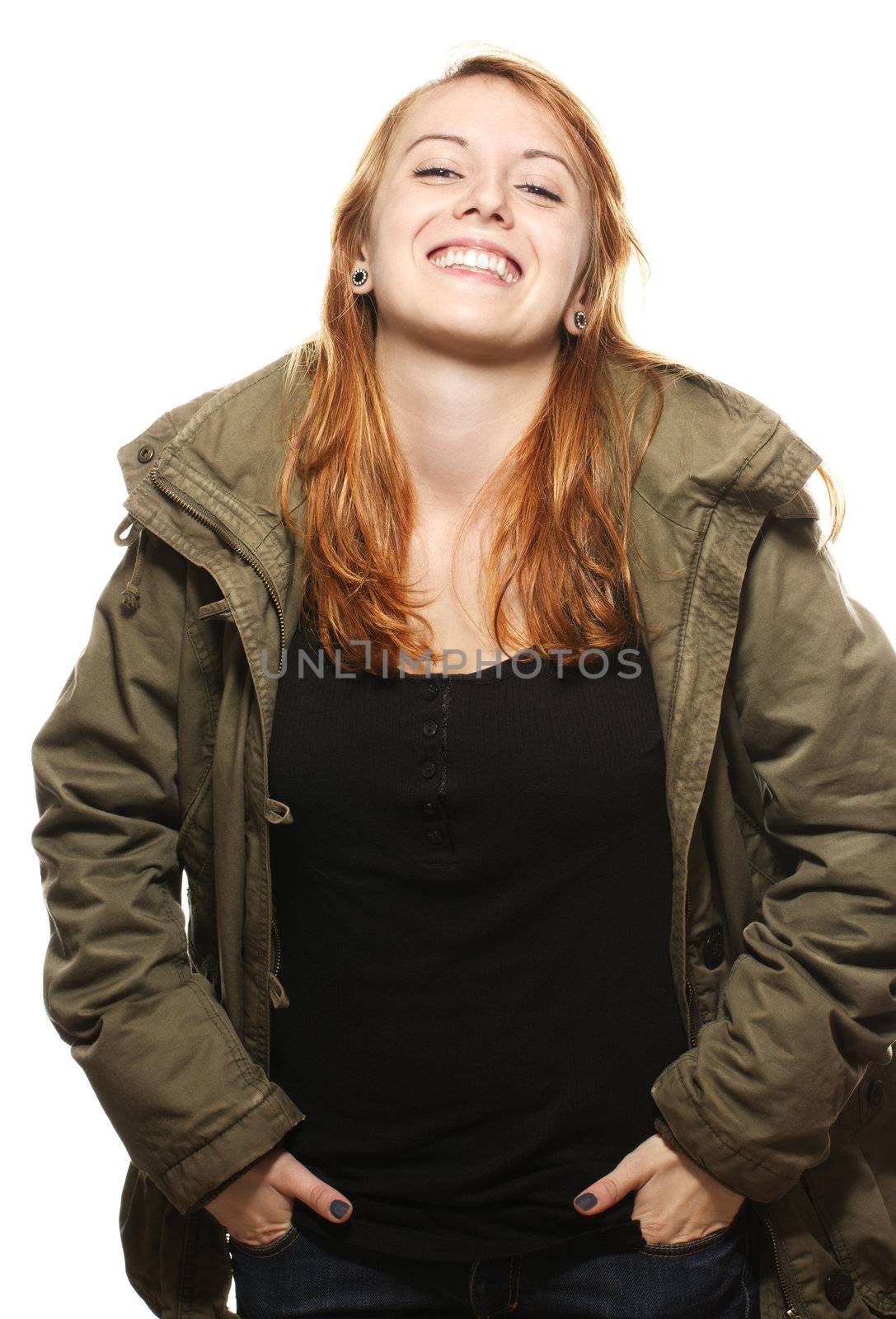 happy young redhead woman in parka on white background