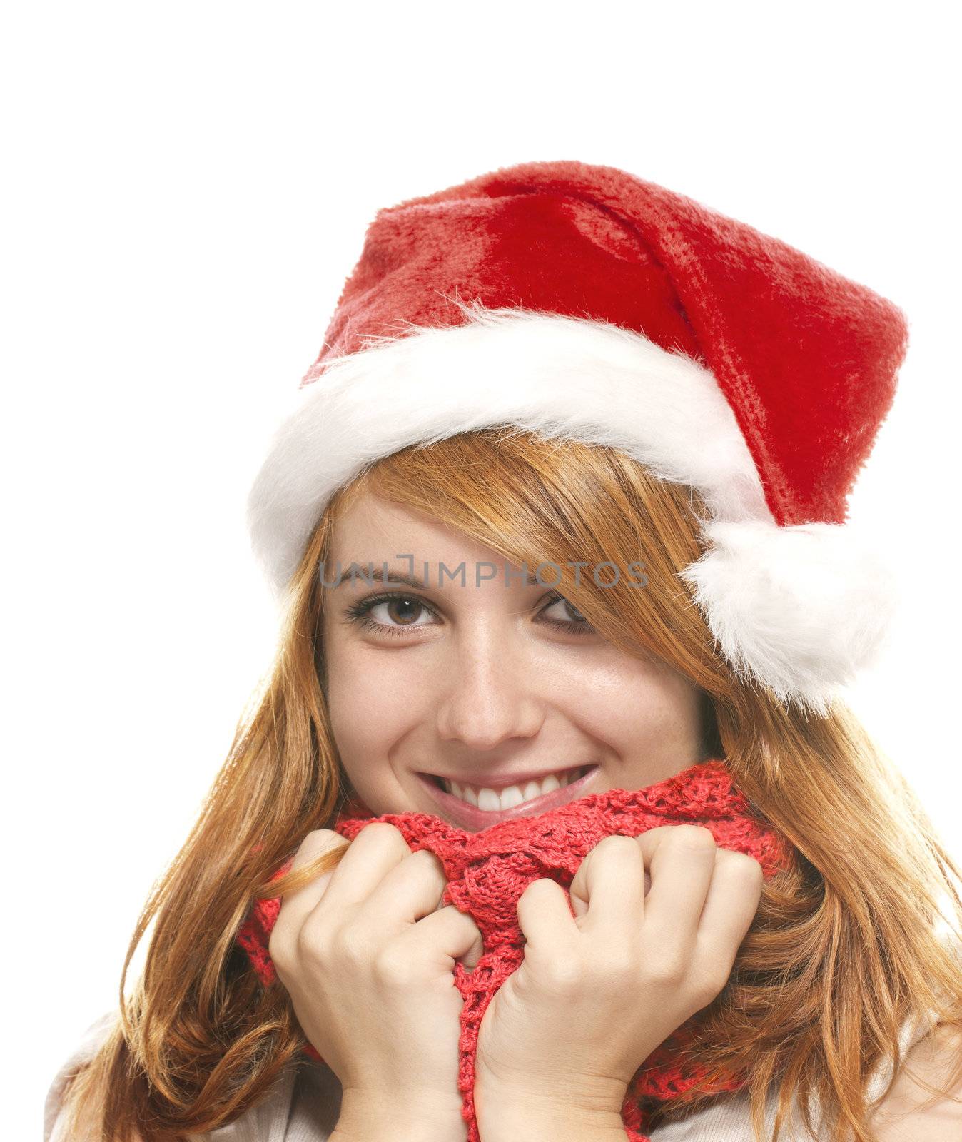 portrait of a happy young redhead woman with santas hat on white background