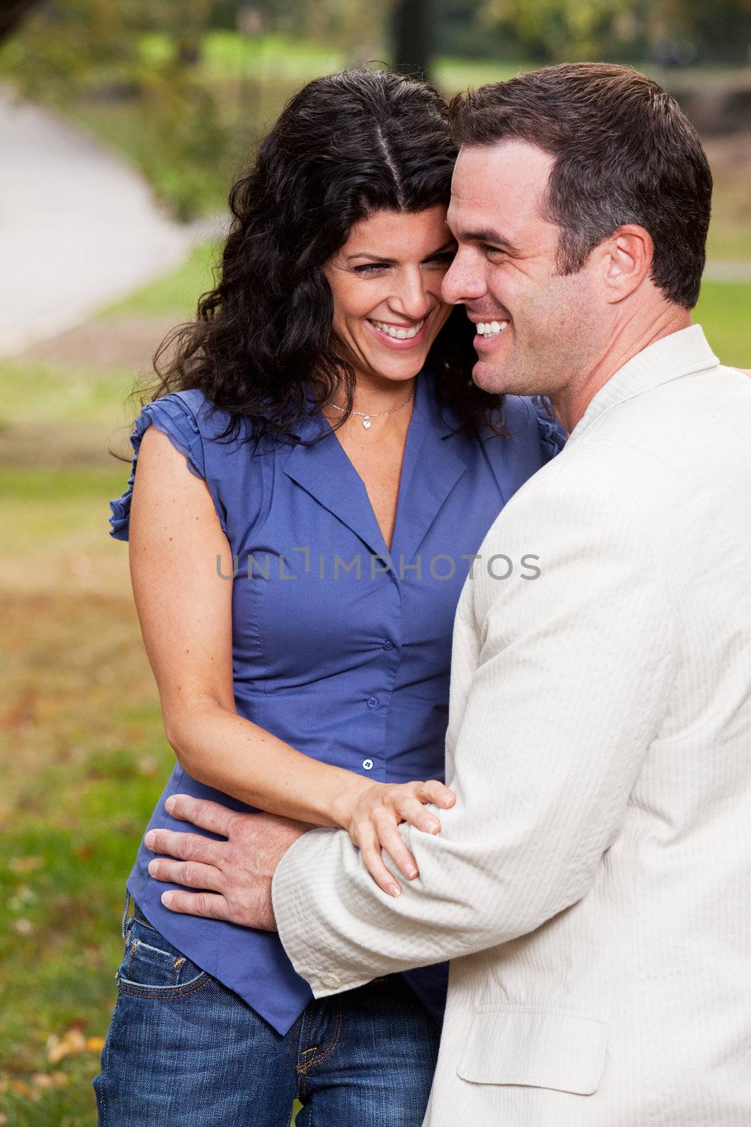 A couple having fun and laughing in the park