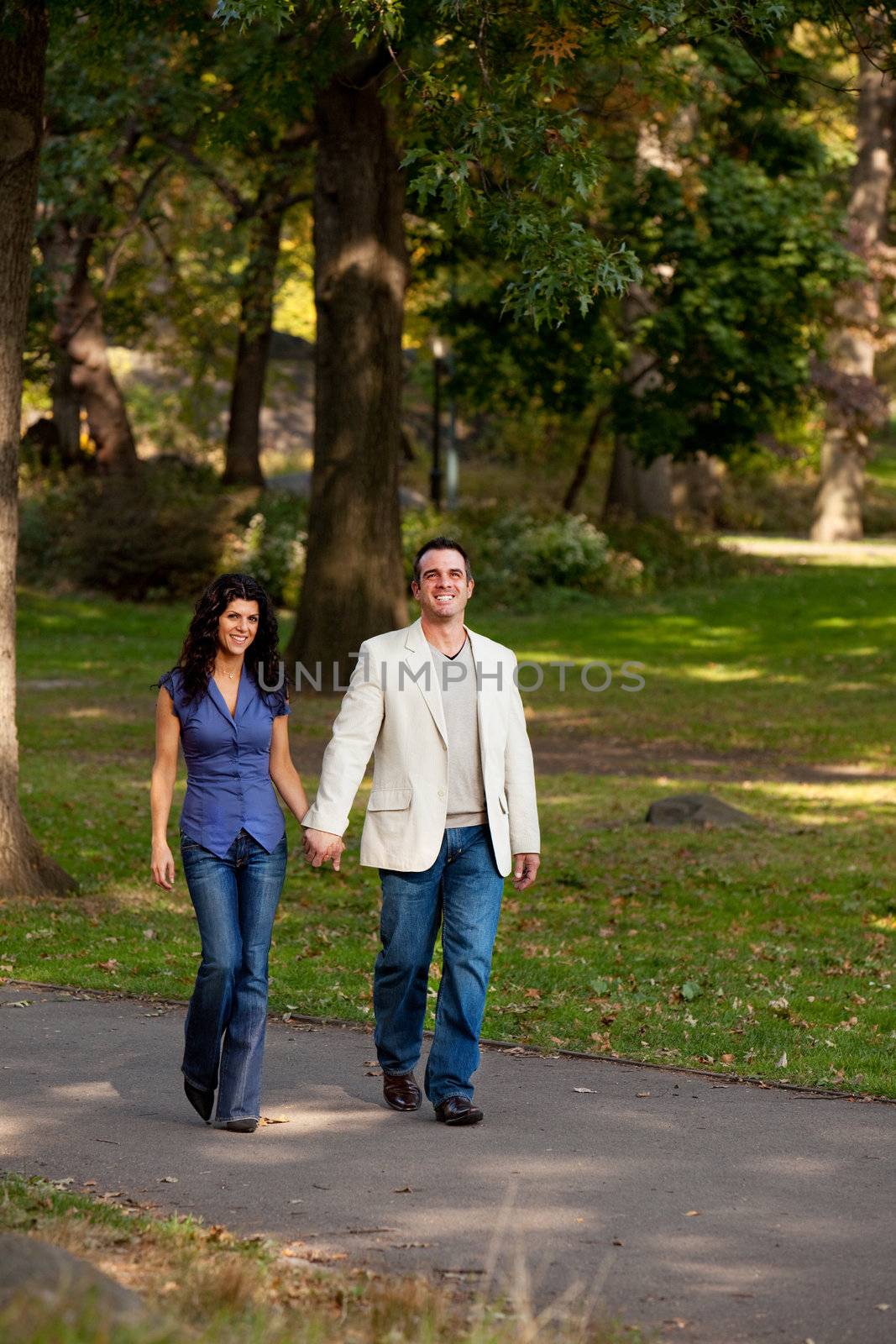A happy couple walking in the park 