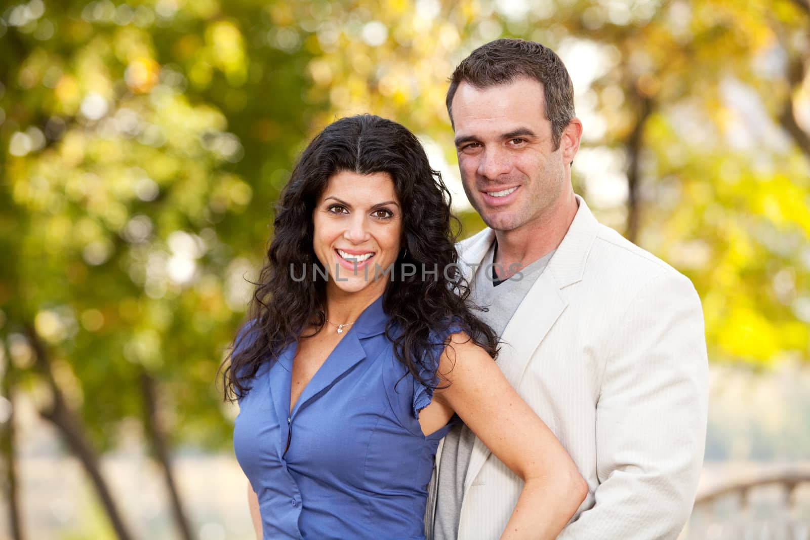 A portrait of a happy male and female in a park