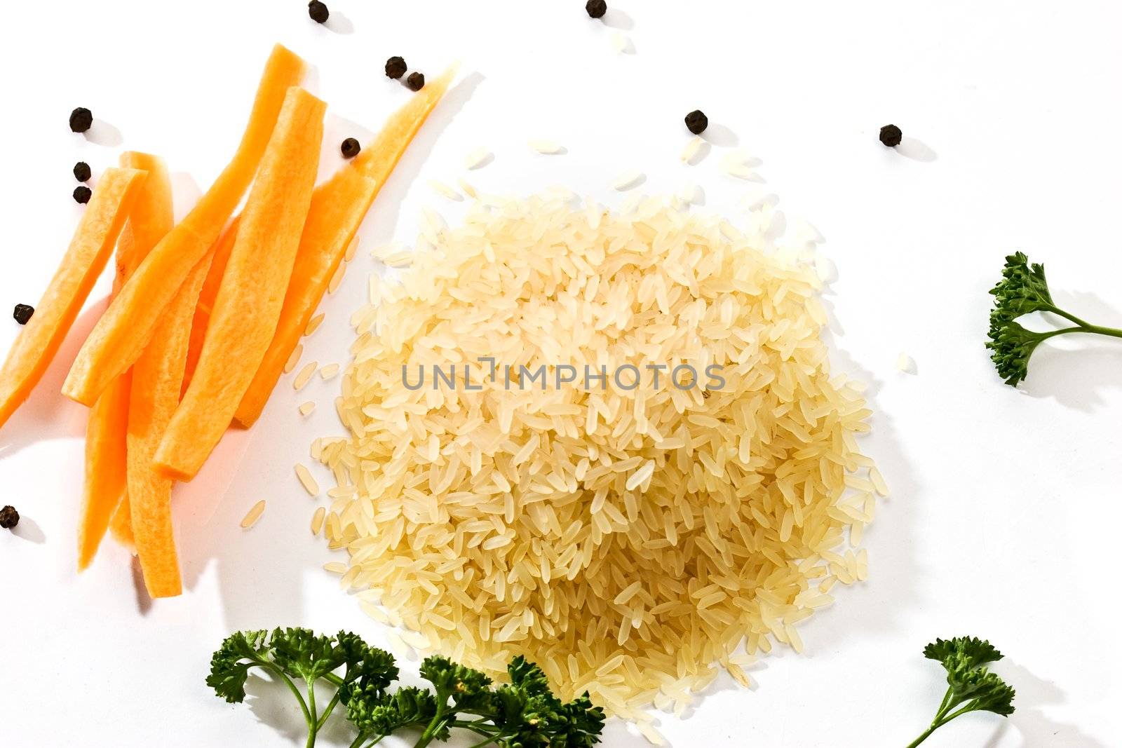 hill of raw rice with vegetables 
and parsley