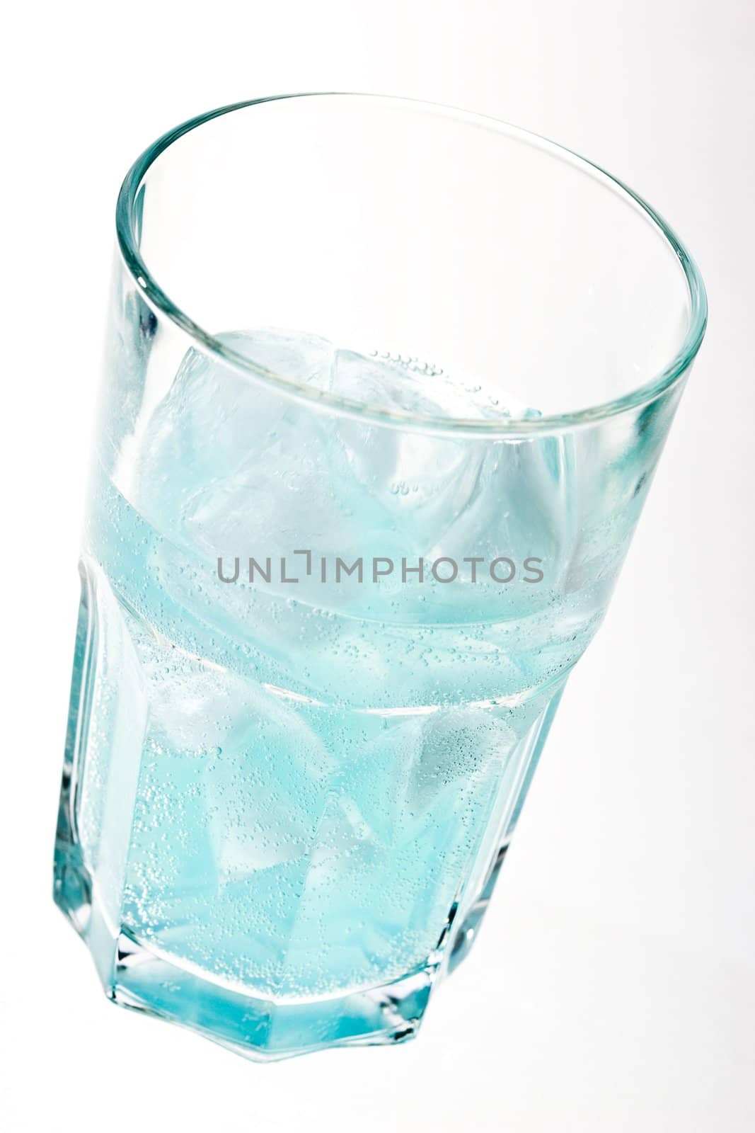 ice in the glass with blue cocktail