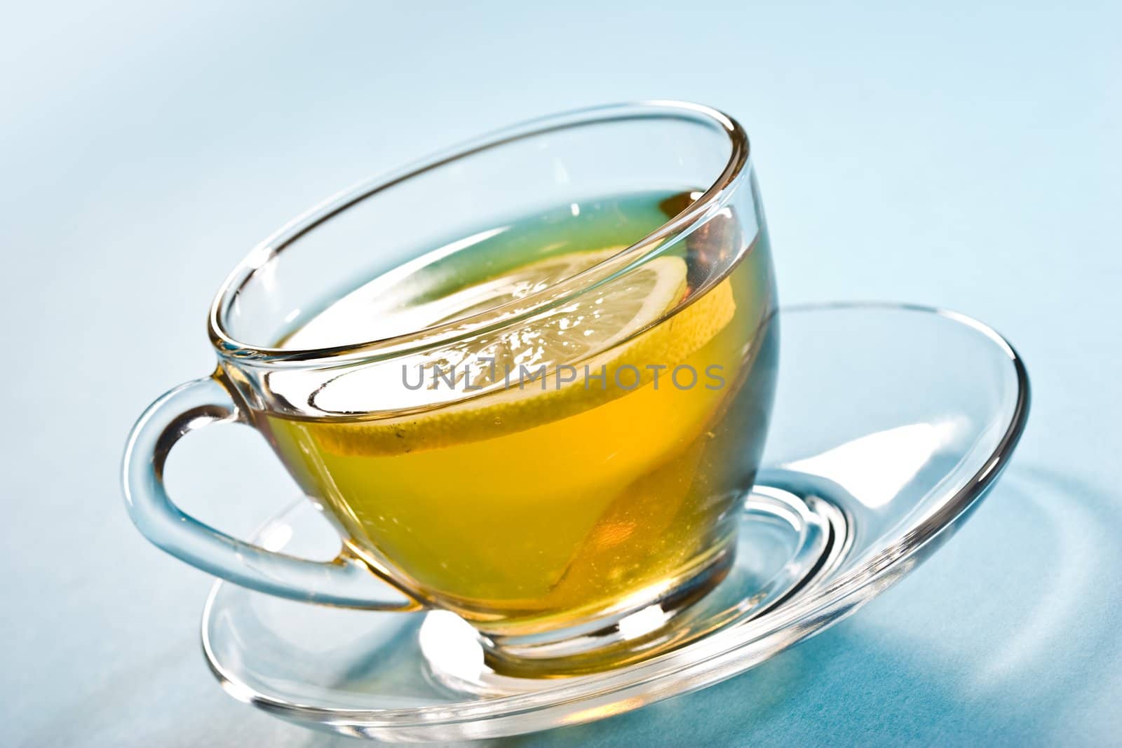 cup of tea with lemon over blue
