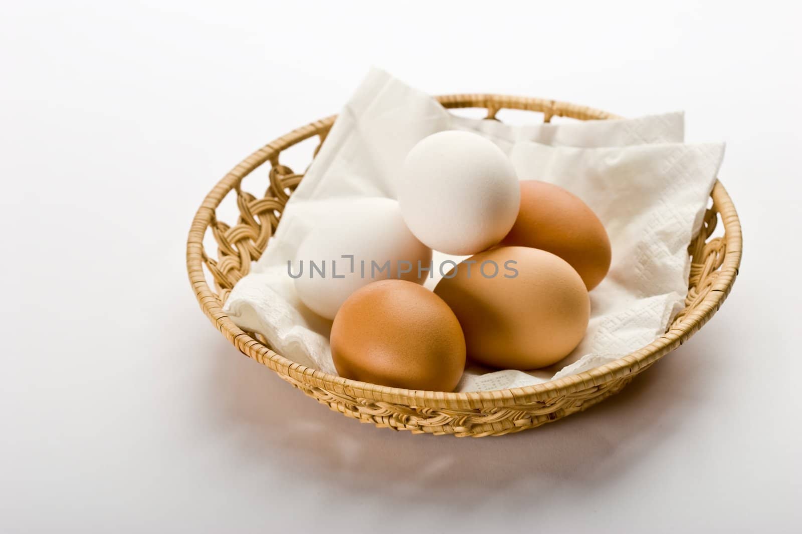 some eggs on the basket over white