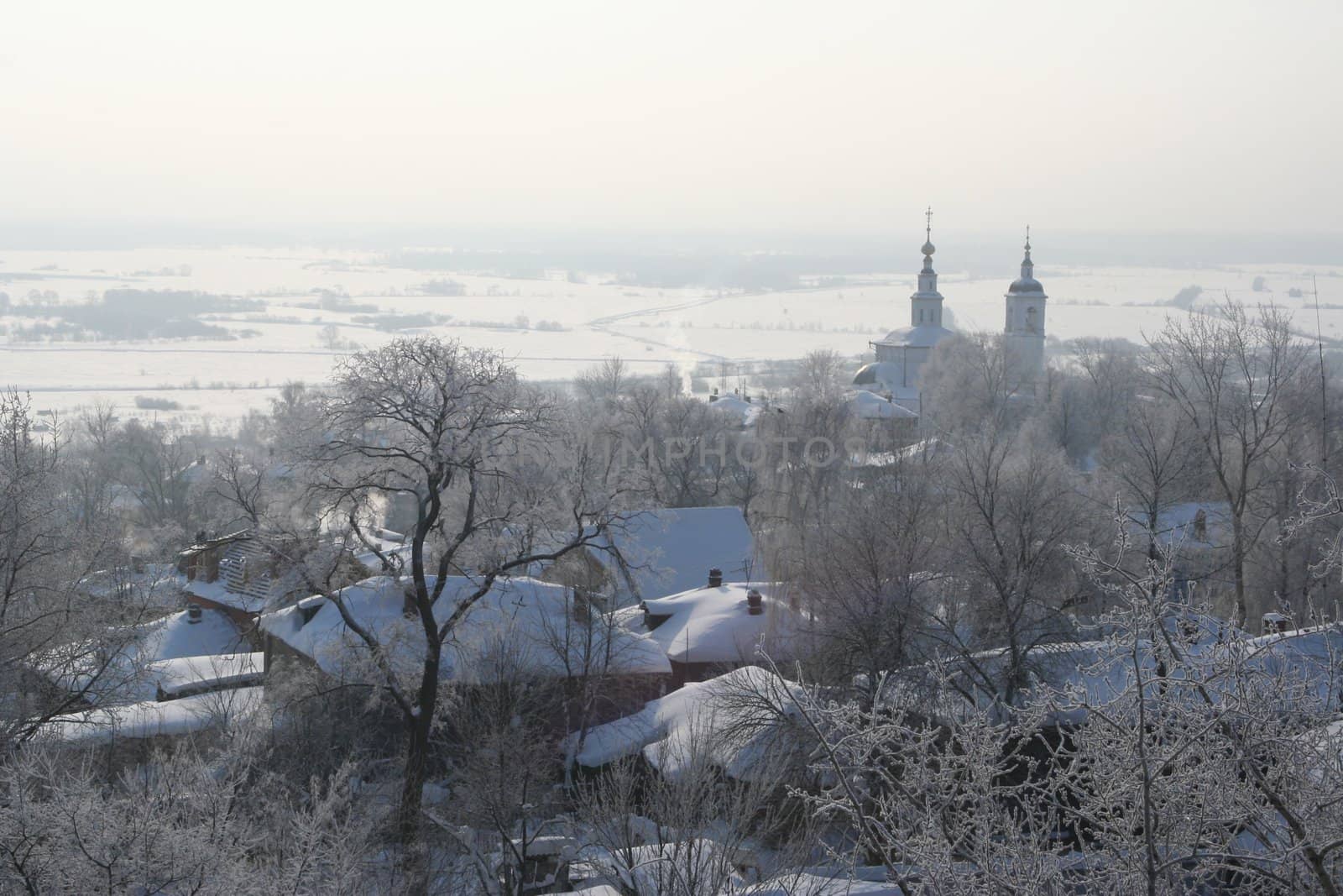 A winter landscape of a little town