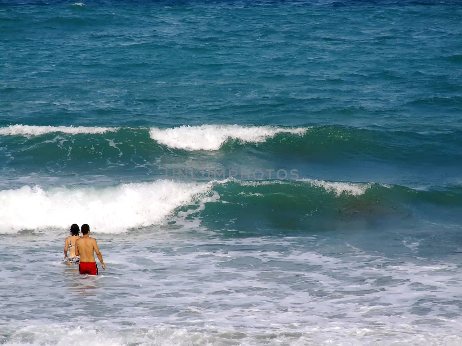 People having fun in the surf on a windy day in Malta