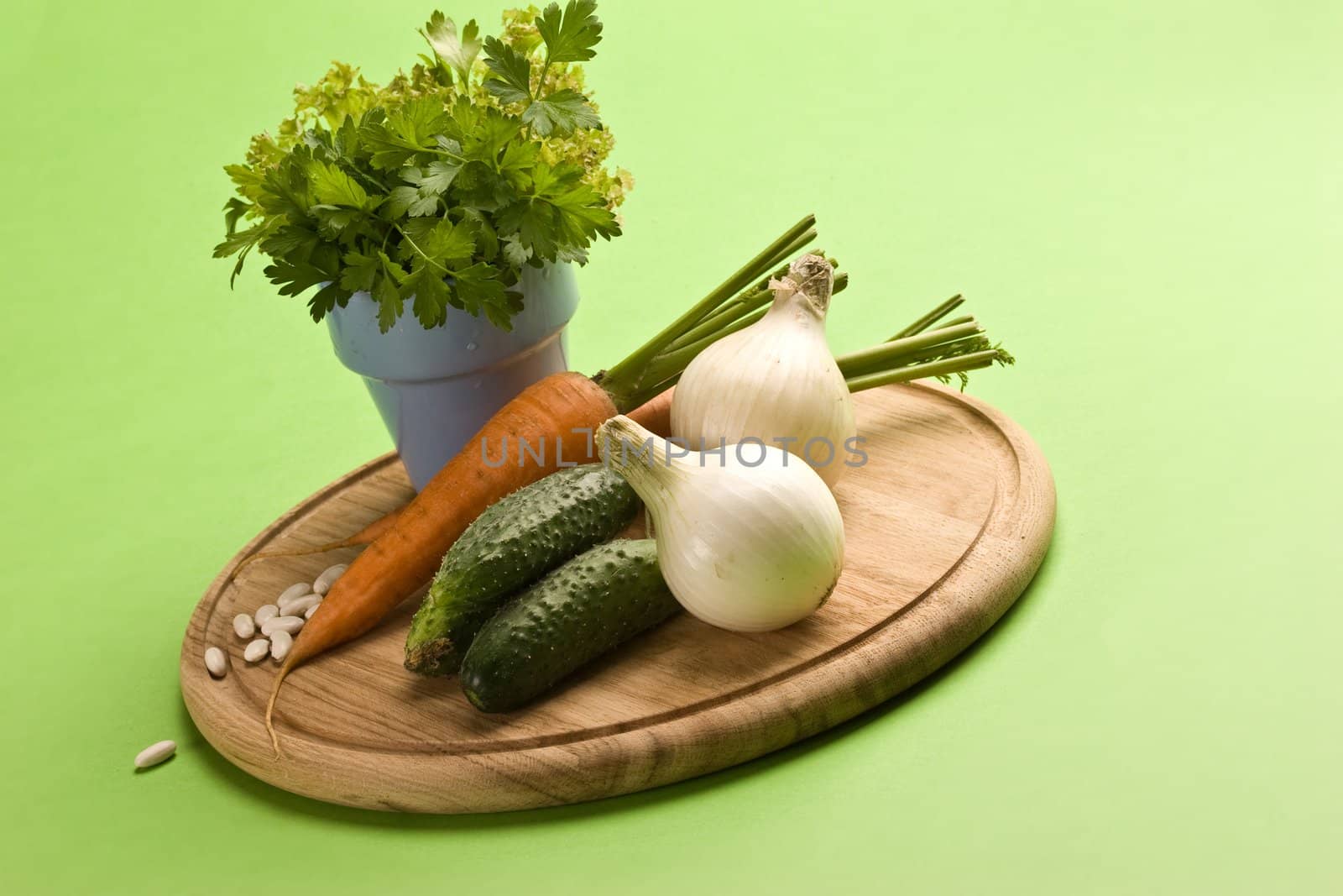 vegeterian food, fresh vegetables: onion, carrot, cucumber and parsley