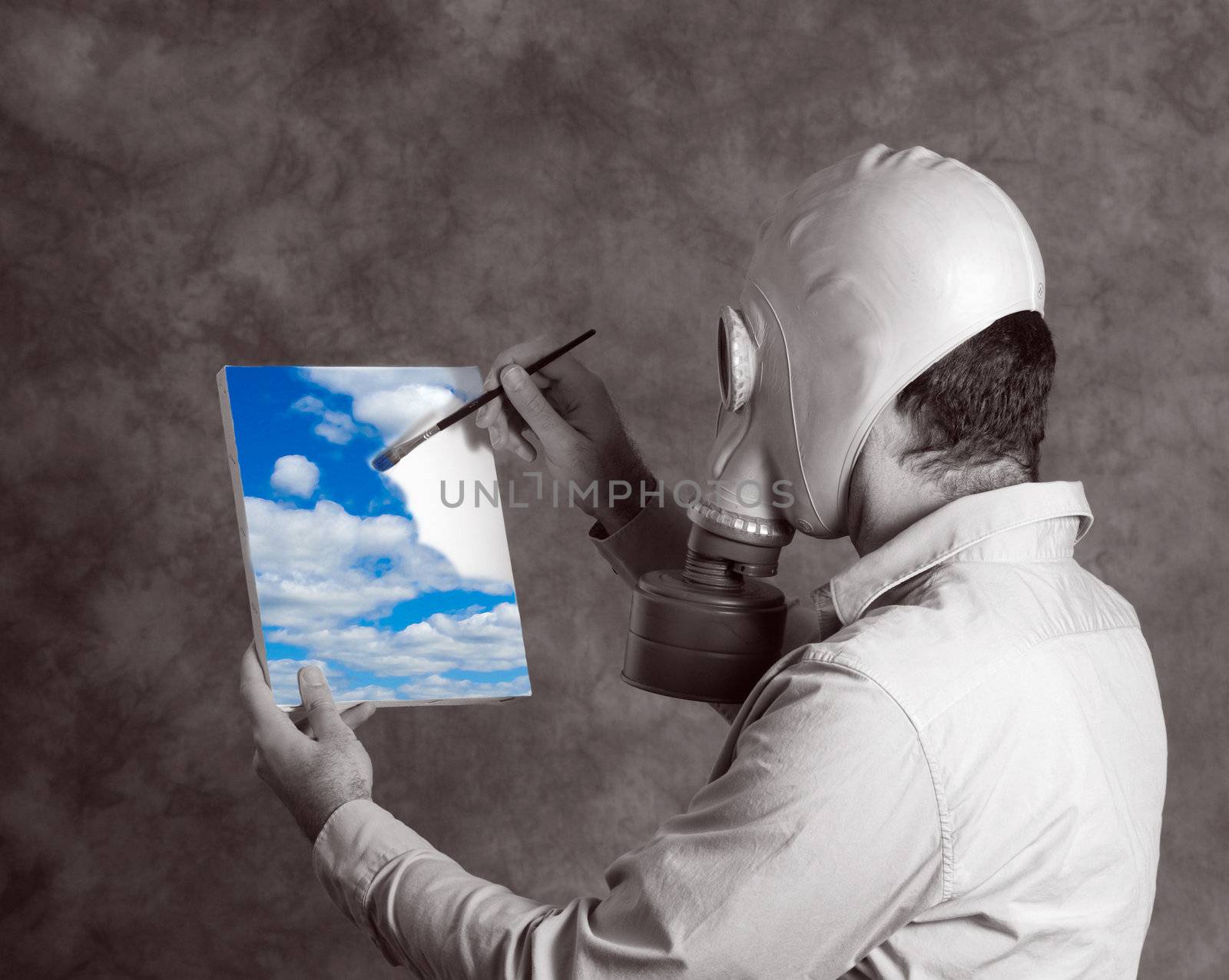 Concept image of a dark world man wearing a gas mask, painting a bright blue sky signifying a utopia world