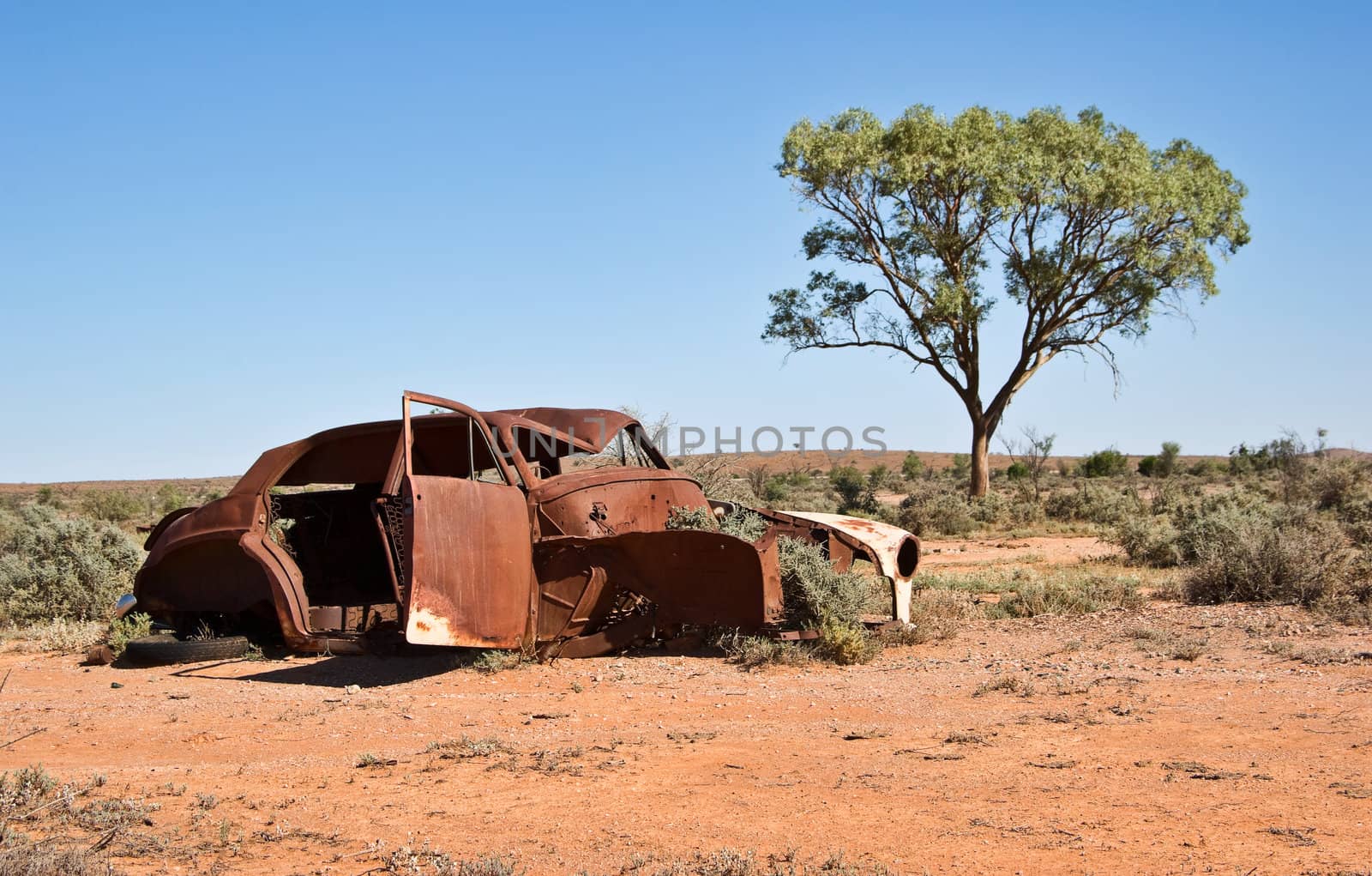 great image of an old car rusting away in the desert
