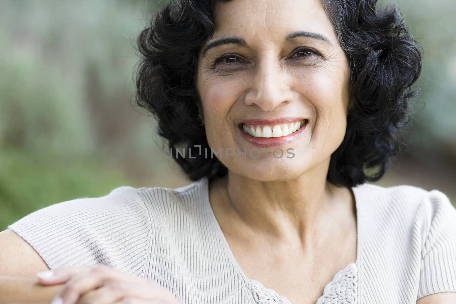 Portrait of a Smiling Mature Indian Woman Looking Directly To Camera
