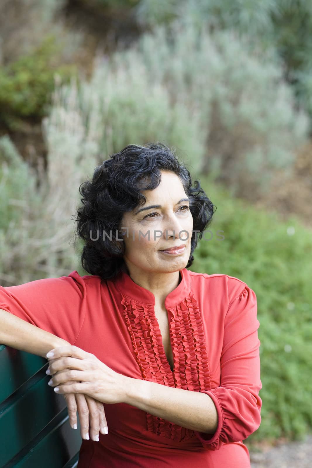 Portrait of a Mature Indian Woman Sitting on a Park Bench