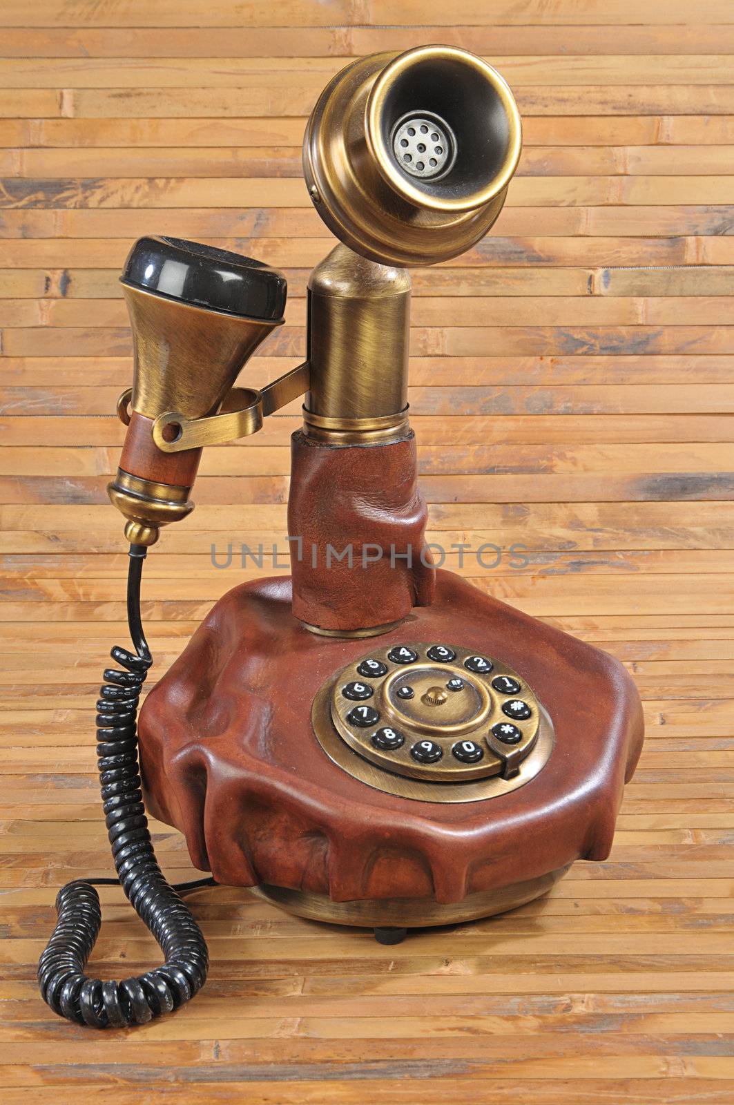 isolated old-fashioned phone on bamboo background