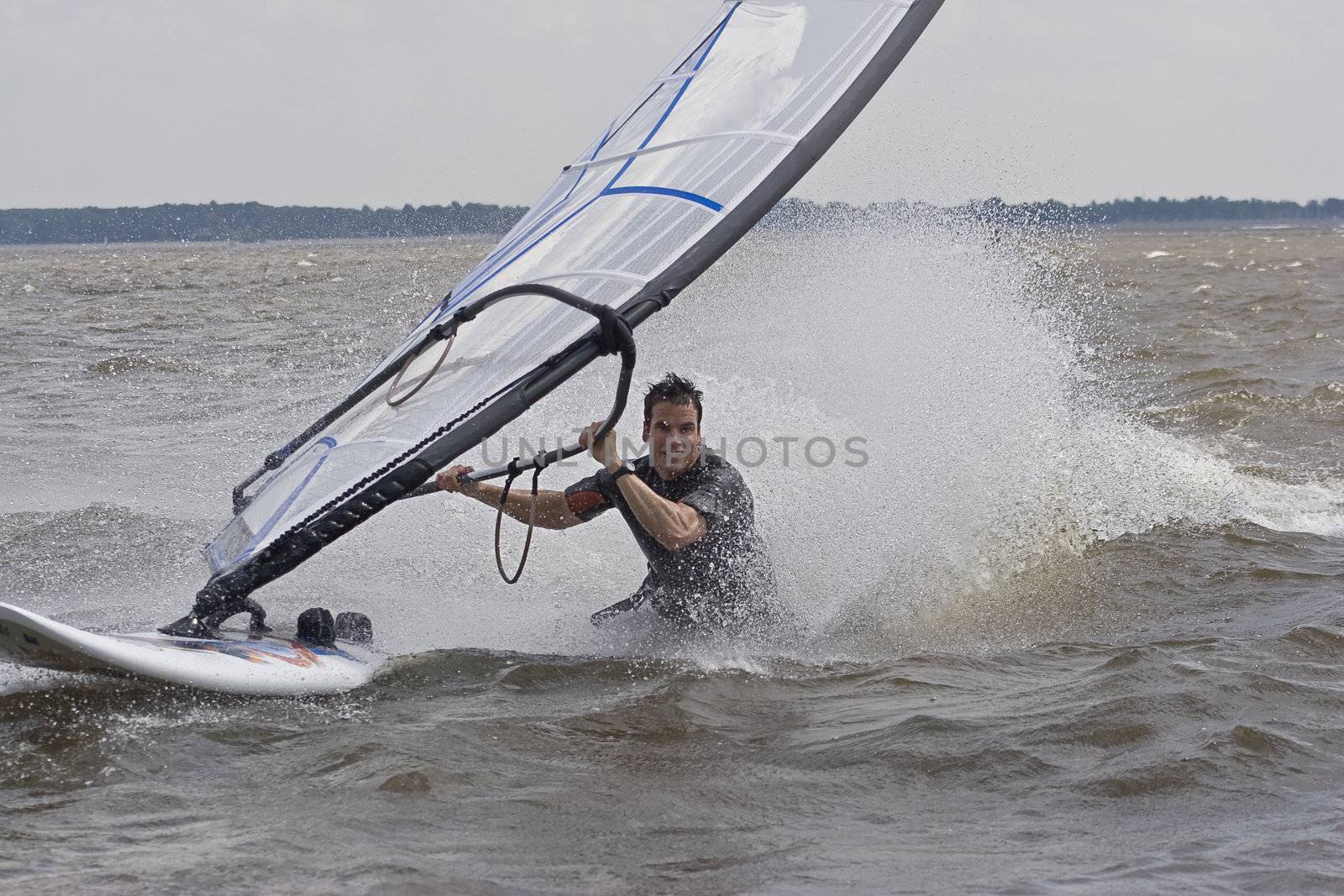 Windsurfer doing a body drag trick in the water