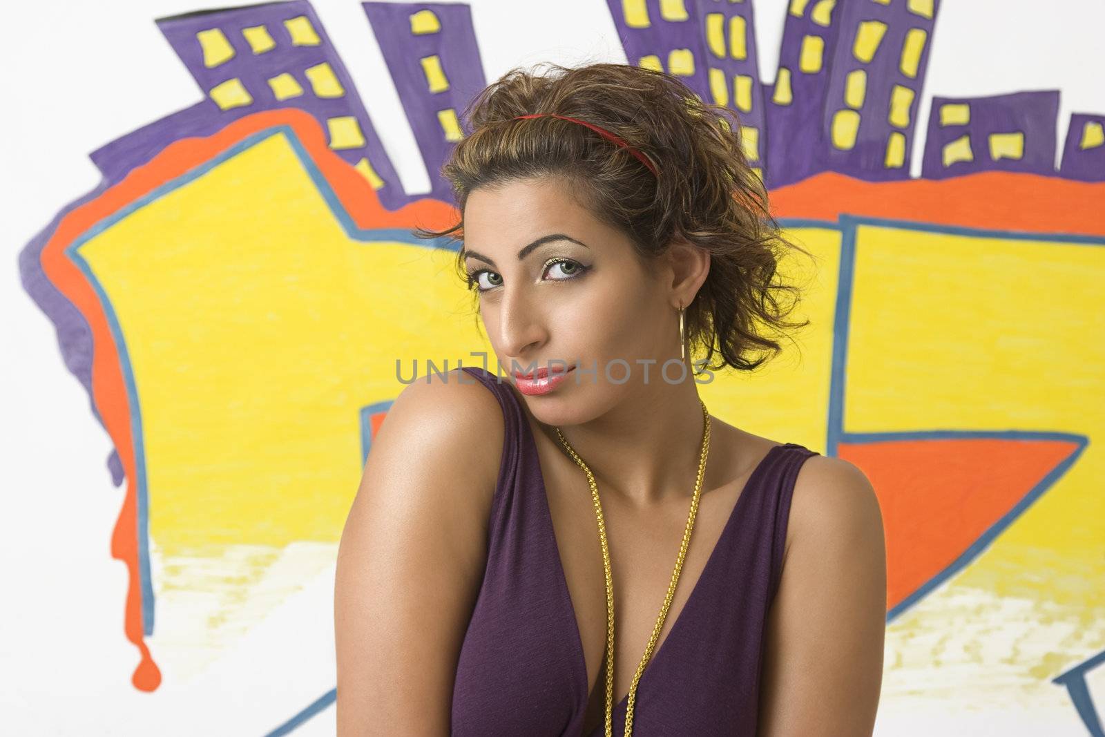 young women with shy behavior in front of graffiti