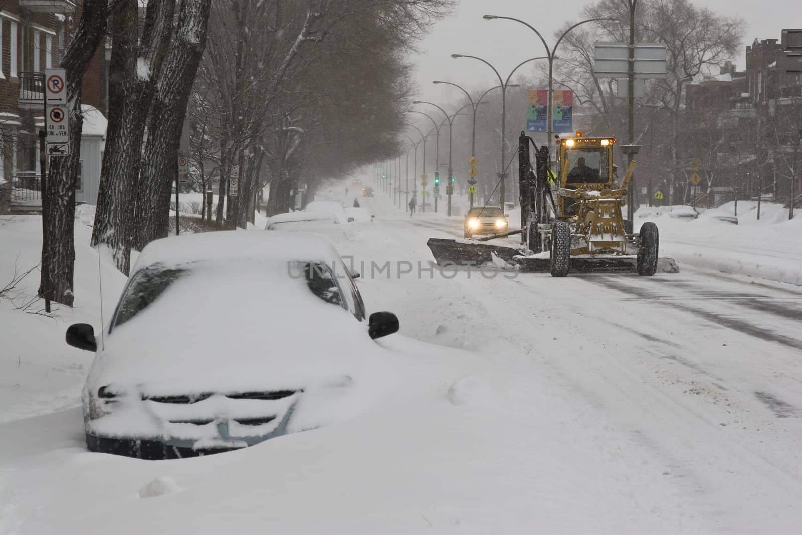 Plow removing snow in the middle of a snow storm