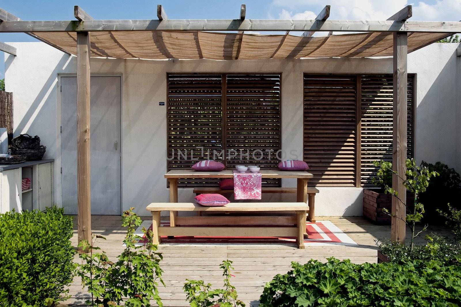 simple outside living place with wood elements and red touch