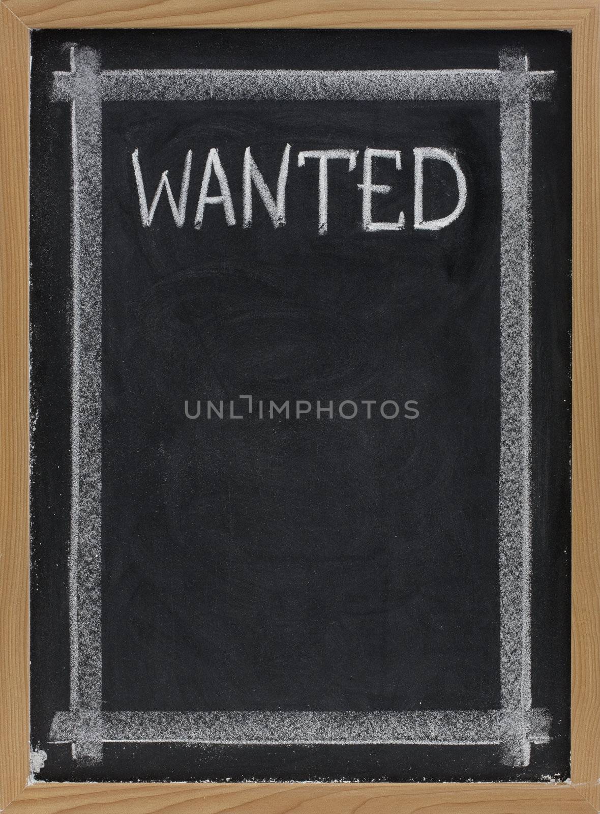 wanted sign handwritten with white chalk on blackboard with copy space below