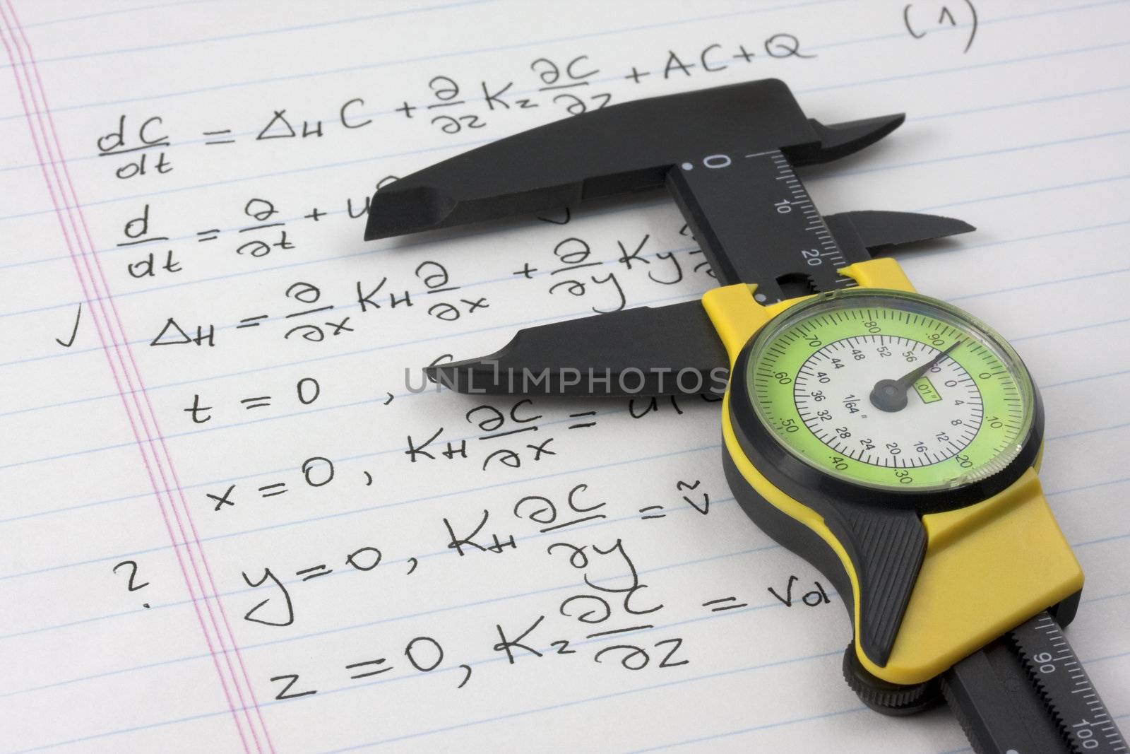 mathematics or physics learning concept - caliper seizing mathematical equations handritten on notebook page