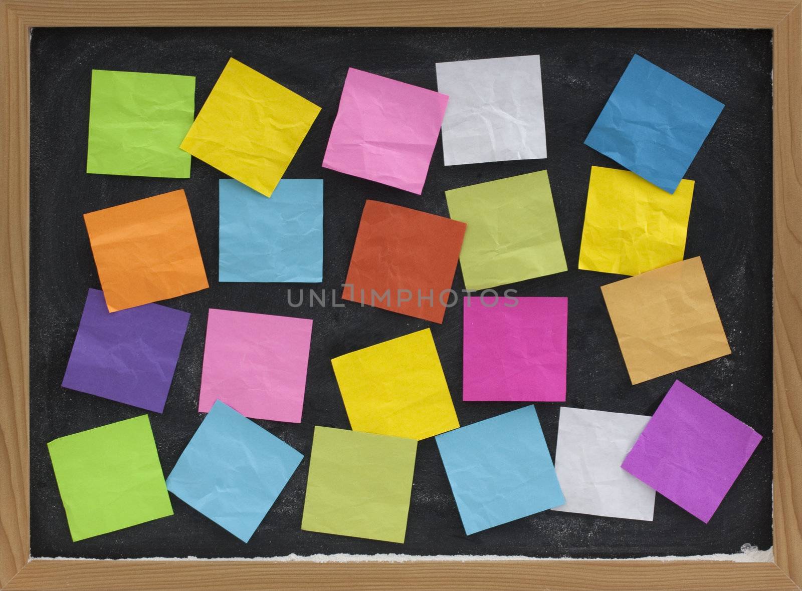 blackboard covered with colorful blank sticky notes