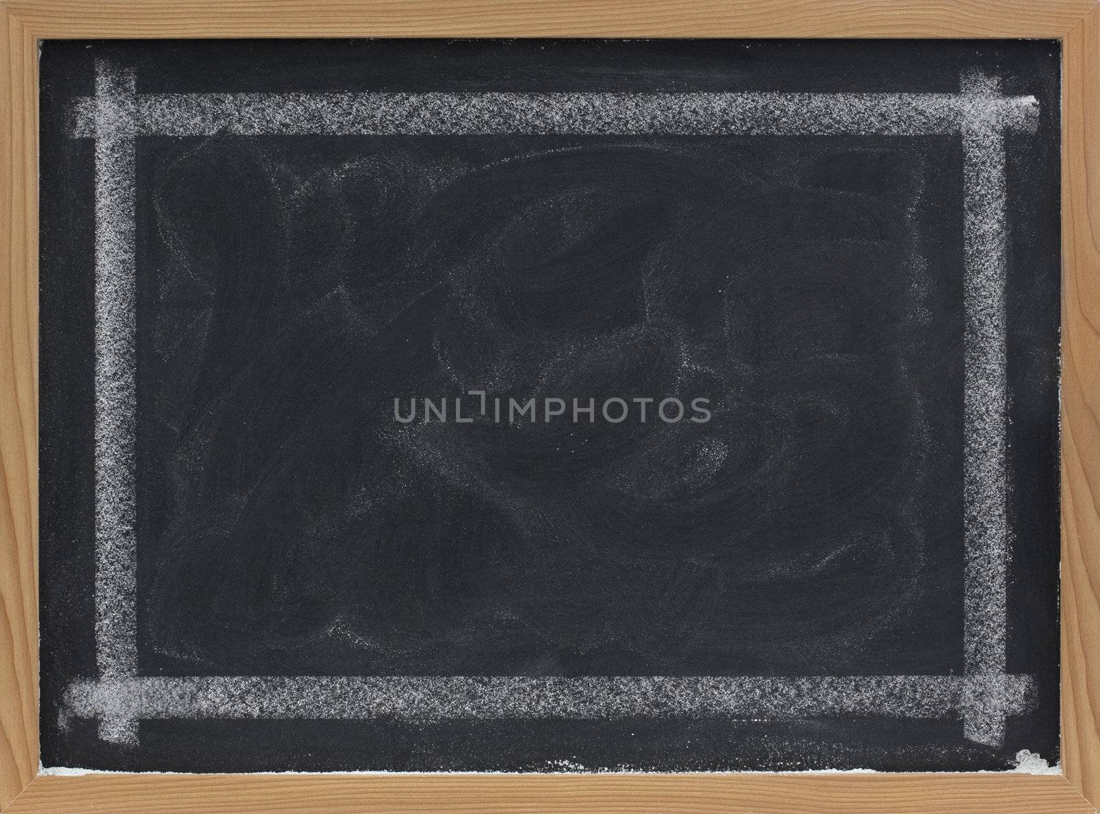 blank blackboard with eraser smudges by PixelsAway