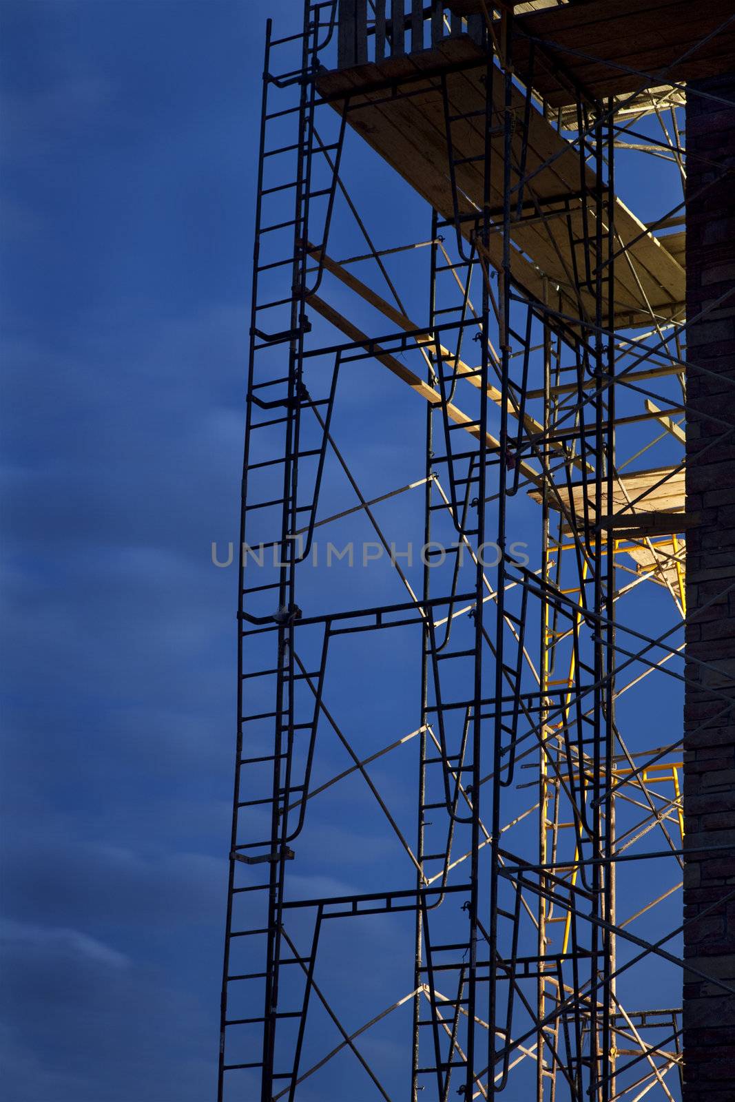 construction scaffolding against nighttime sky by PixelsAway