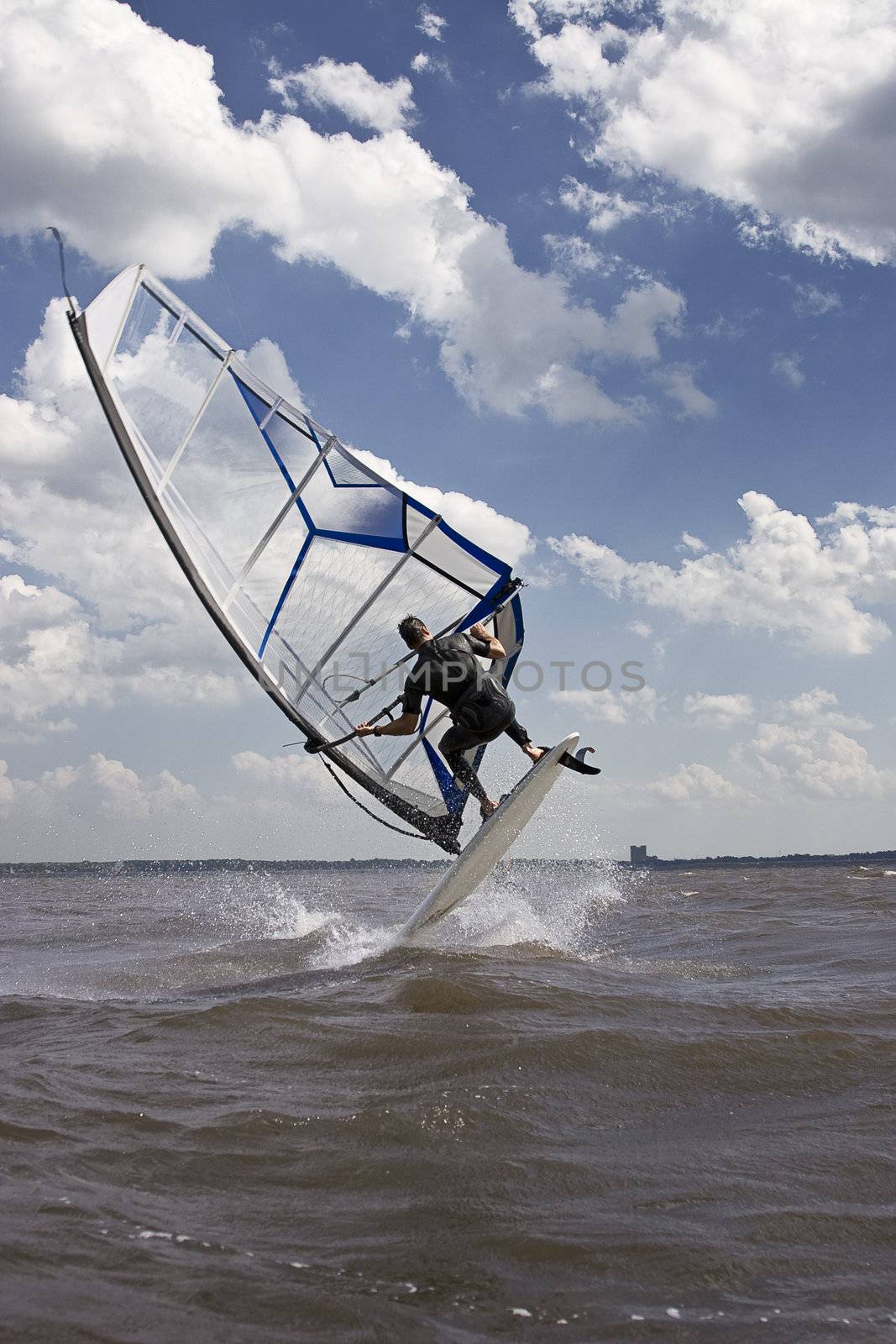 Windsurfer doing a jump trick in the water