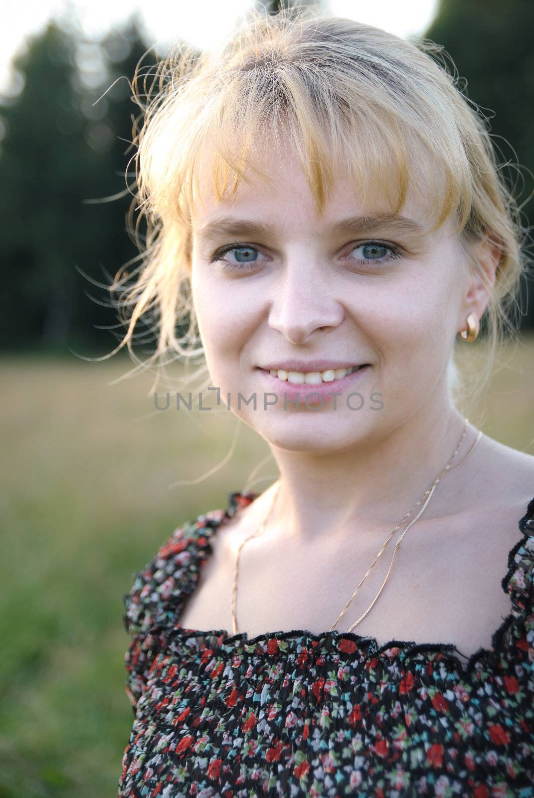 Girl in the meadow looking at camera by jordano