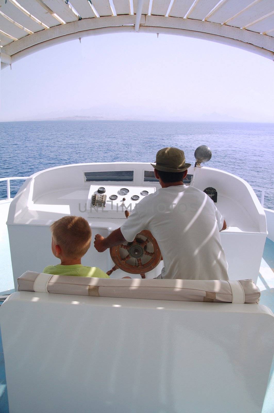 little boy and captain on the boat 2