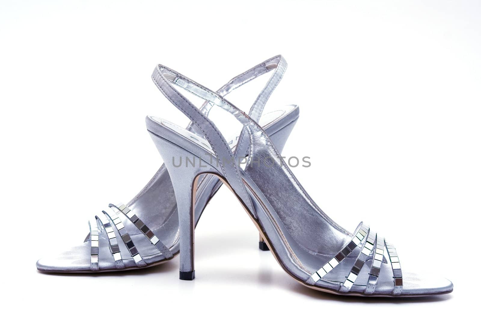 Elegant female shoes with a high heel on a white background