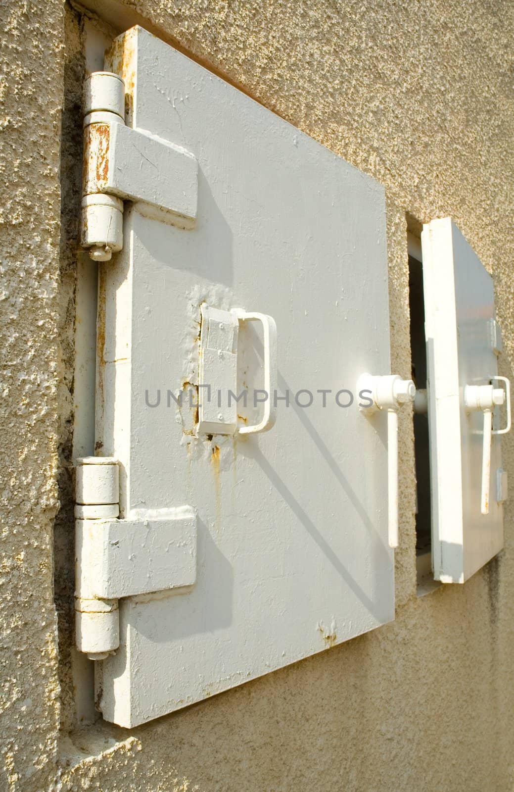 Iron door shelter in concrete wall. Background for graphic design
