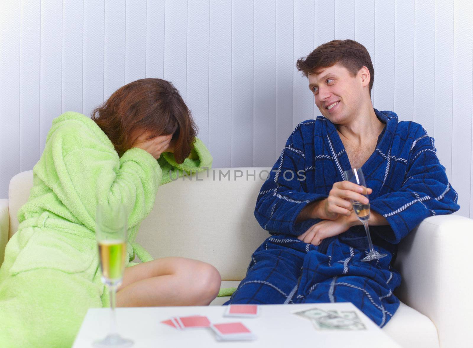 Woman has lost in cards to man and cries by pzaxe