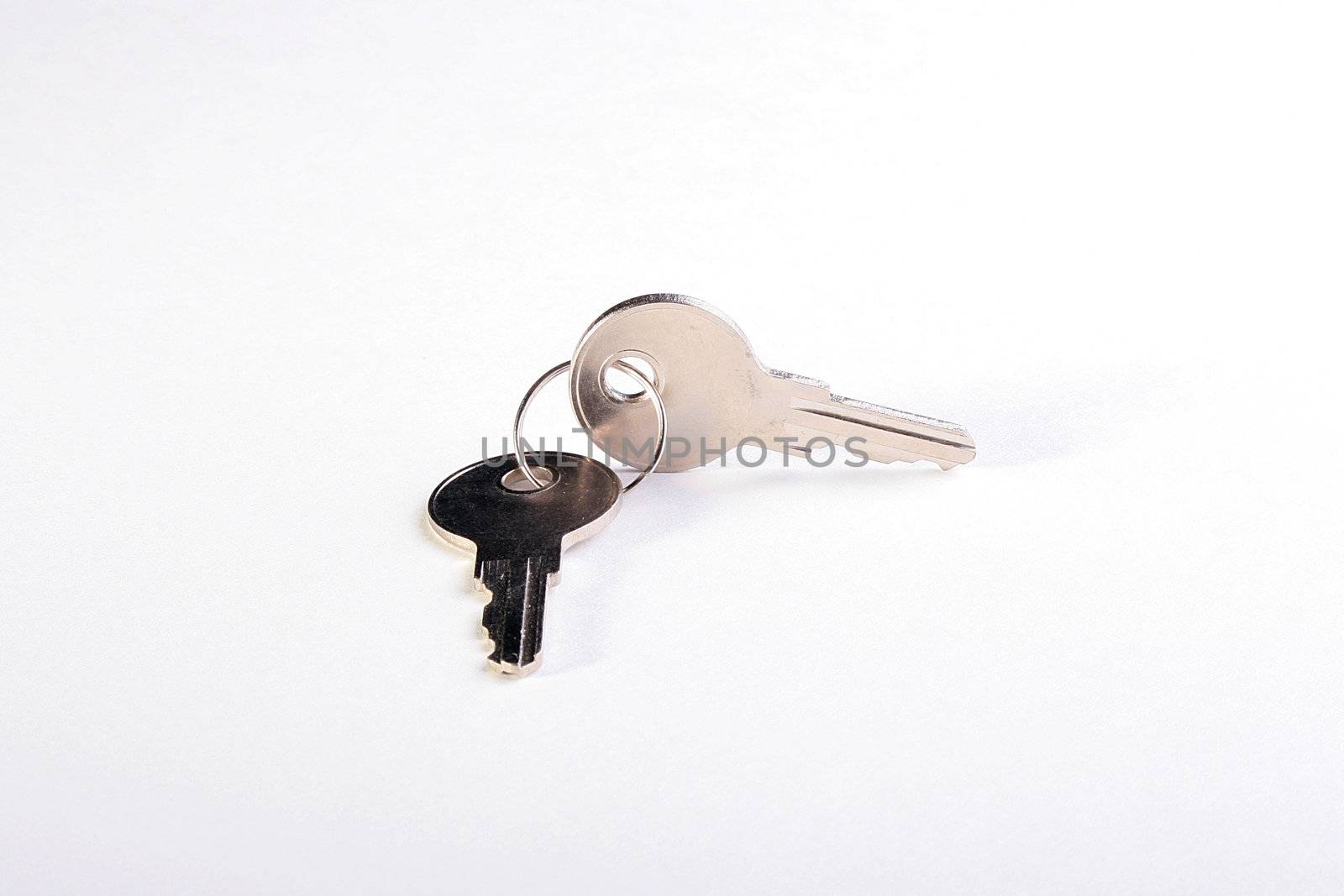 Two keys on a ring for a door-lock on a white background.