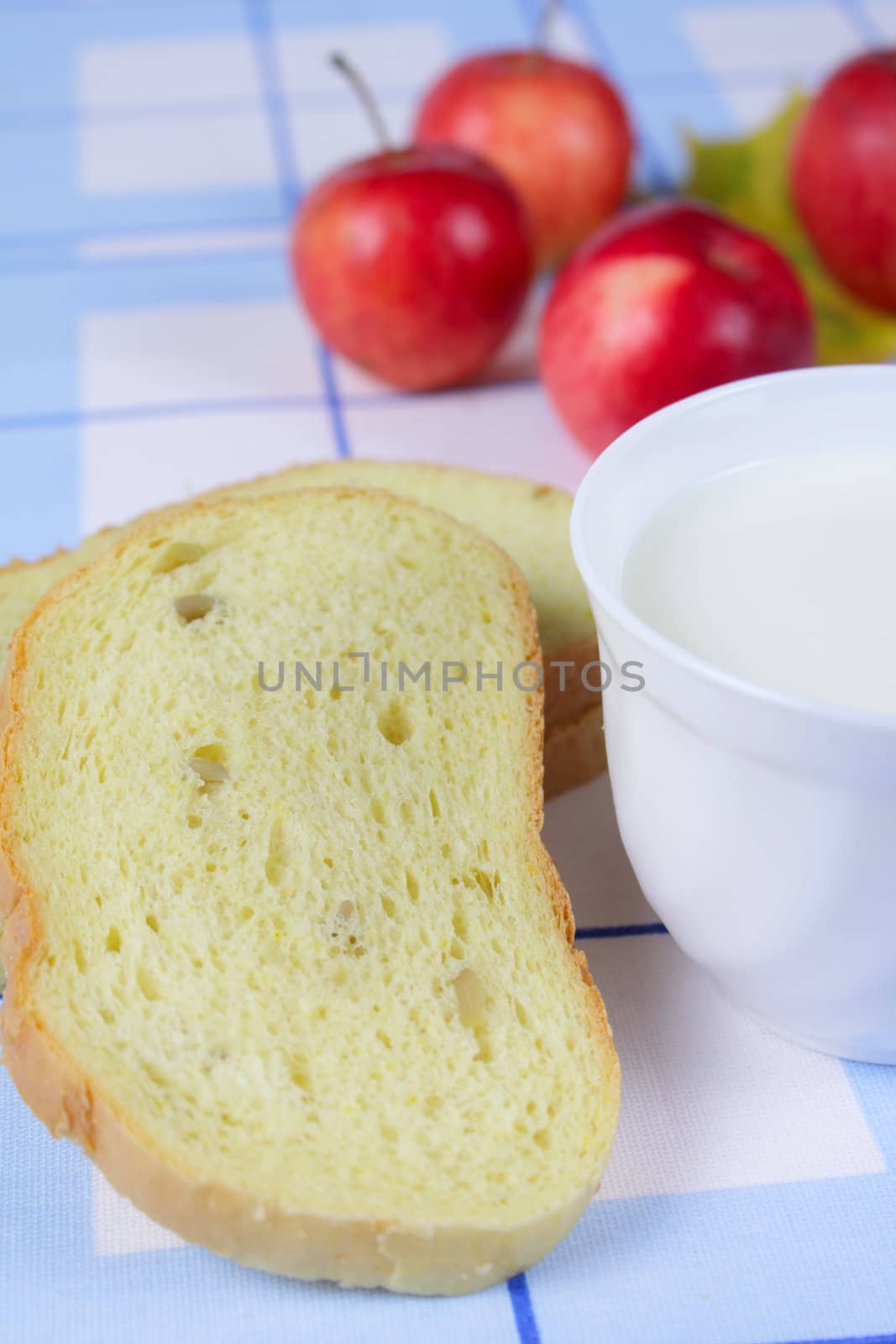 Cornbread with milk and apples on a linen napkin removed close up