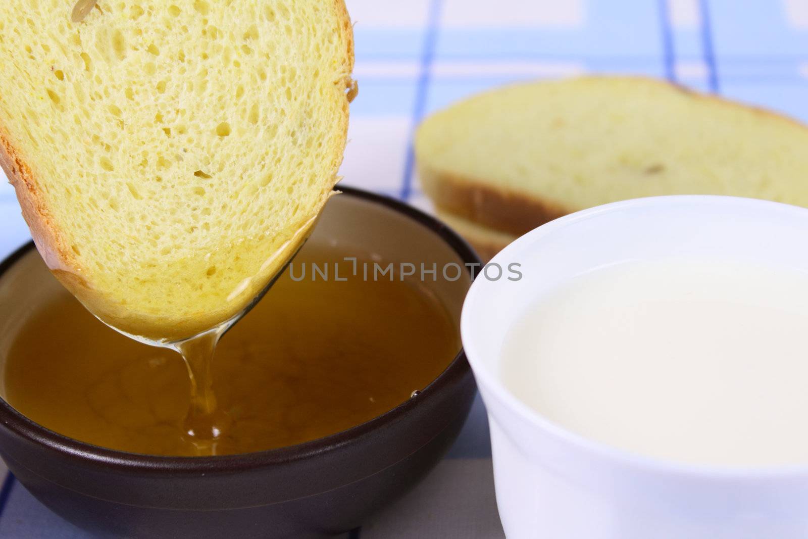 Cornbread with milk and honey on a linen napkin removed close up