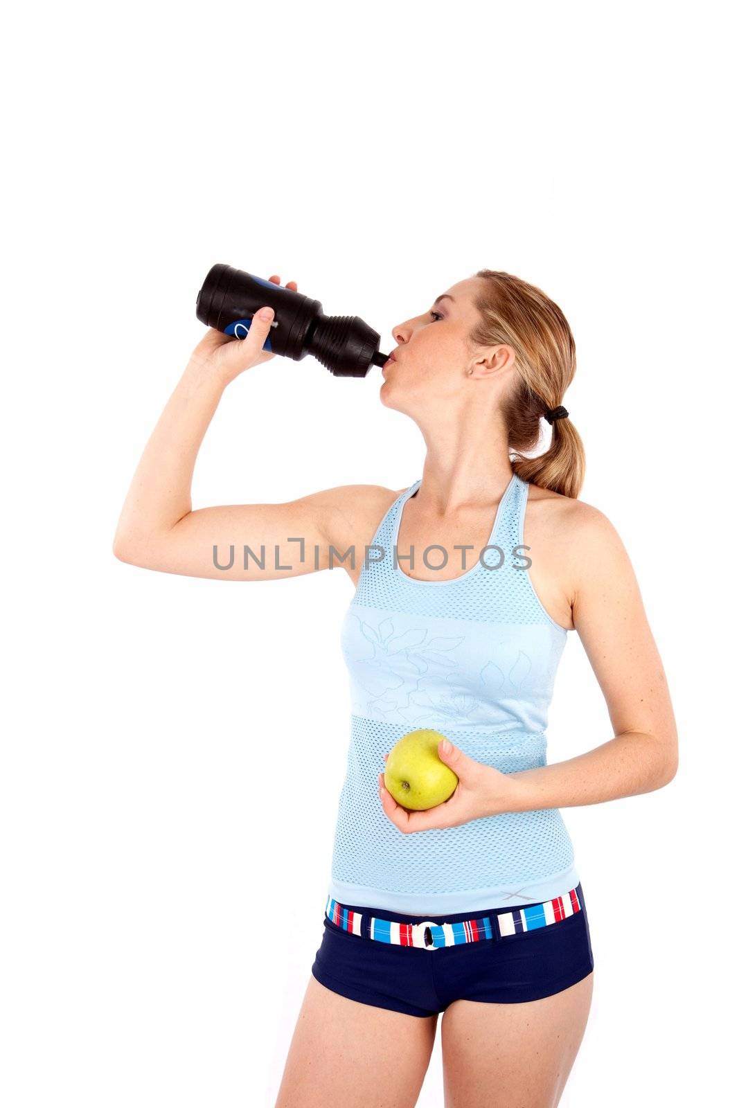 Woman drinking water and holding apple isoalted