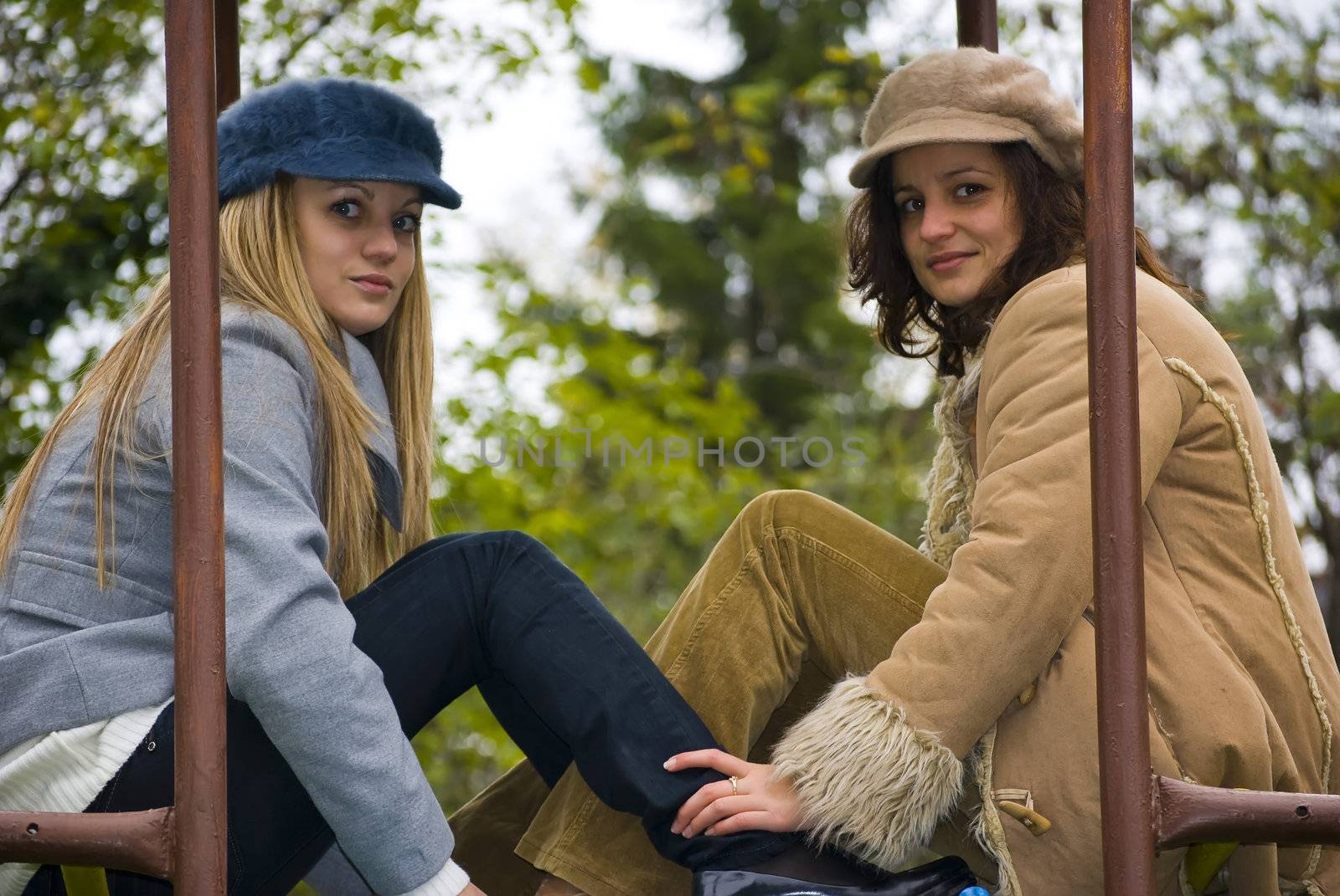 two cute girls having fun outdoors in autumn