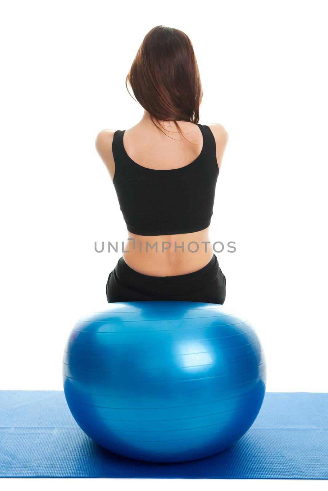 Fitness women exercising on fitness ball Shot from behind. Isolated on white
